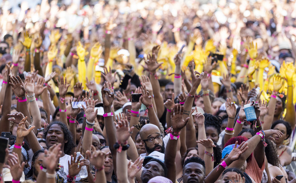 The crowds raise their hands during 6lack's performance Friday, June 17.