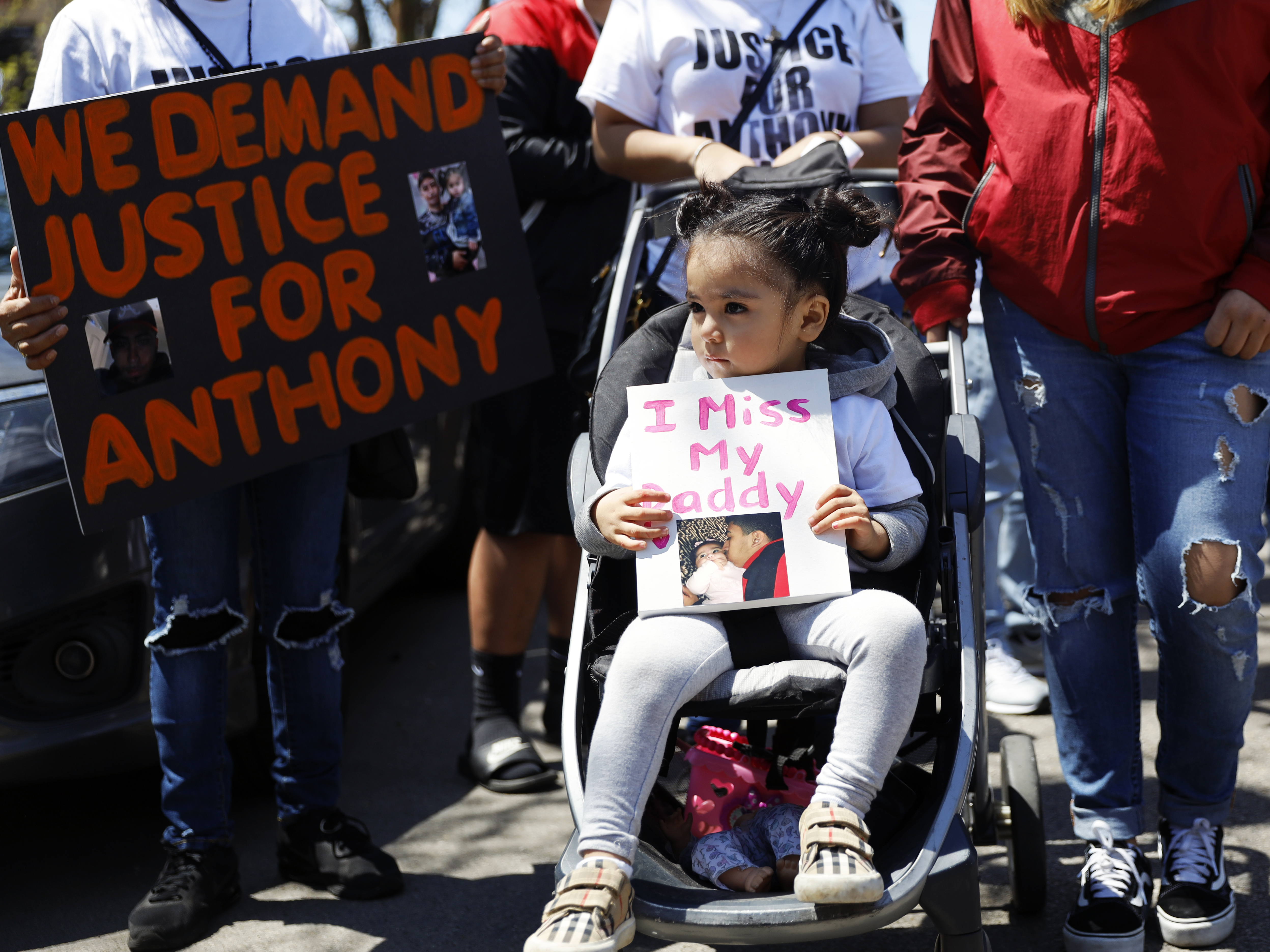 In this May 1, 2021 photo, Ailani Alvarez, 2, daughter of Anthony Alvarez who was shot by the police, holds a sign reading "I miss my daddy" during a protest in Chicago.