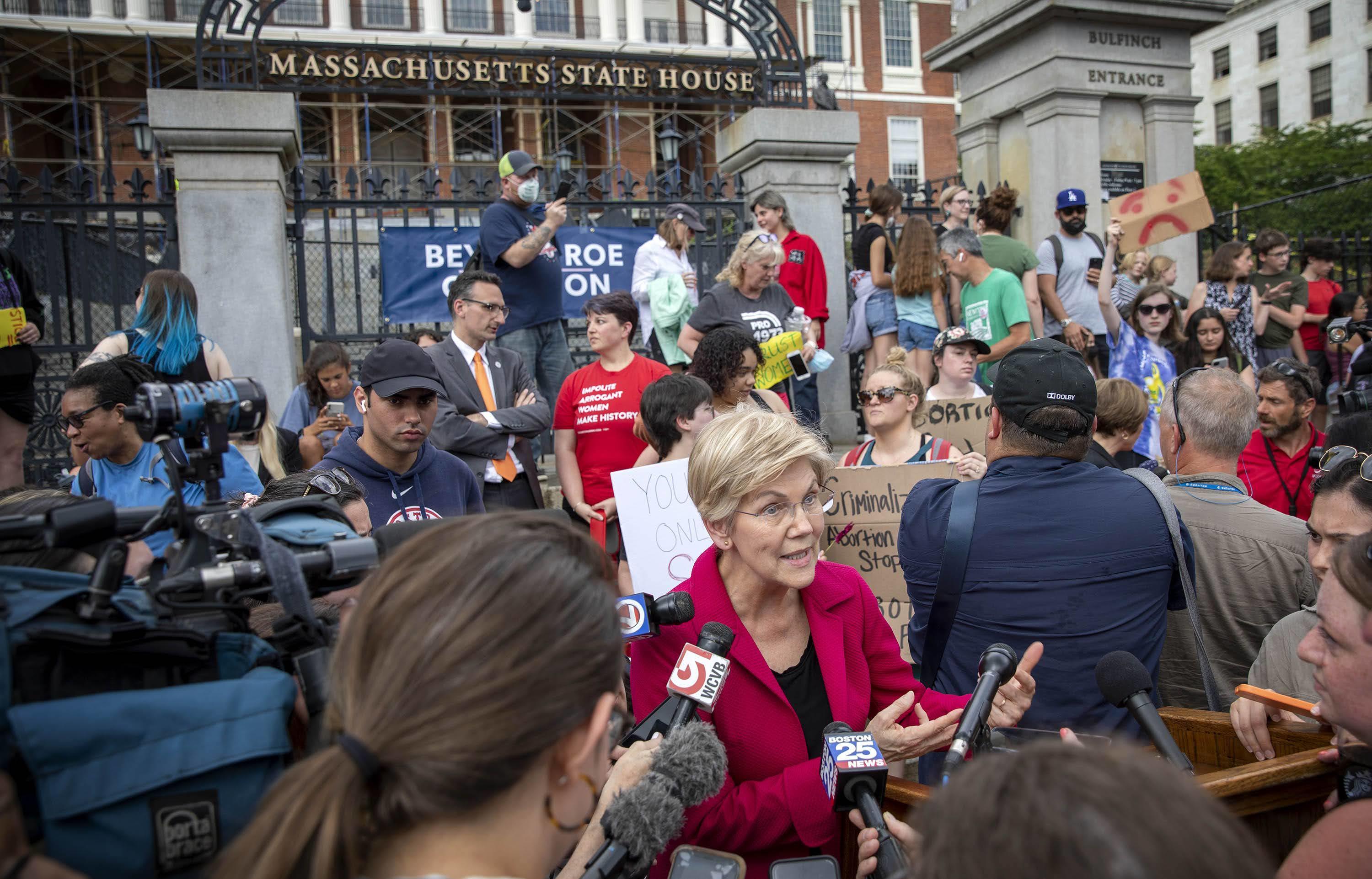 Sen. Elizabeth Warren speaks with reporters in front of the Massachusetts State House following the Supreme Court's decision to overturn Roe v. Wade.