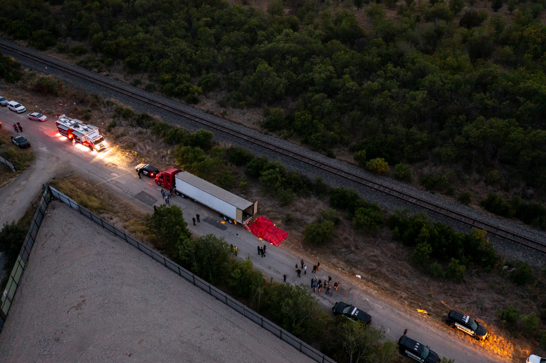In this aerial view, members of law enforcement investigate a tractor trailer on Monday in San Antonio, Texas. (Jordan Vonderhaar/Getty Images)