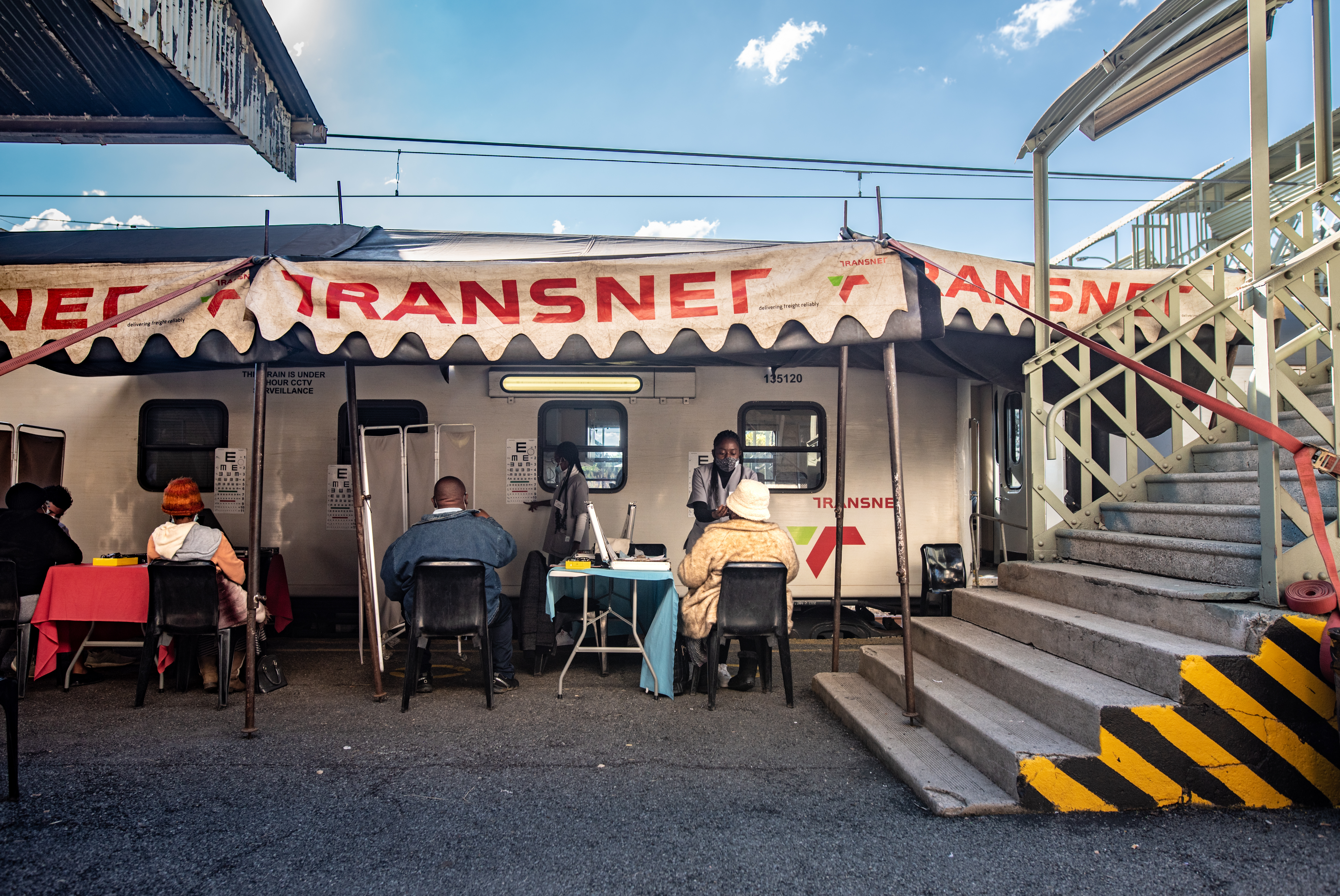 PHOTOS: South Africa's 'train of hope' is a godsend for millions. But new threats loom 2 Patients get their eyes tested by medical staff outside the Phelophepa health-care train in Kroonstad, South Africa.