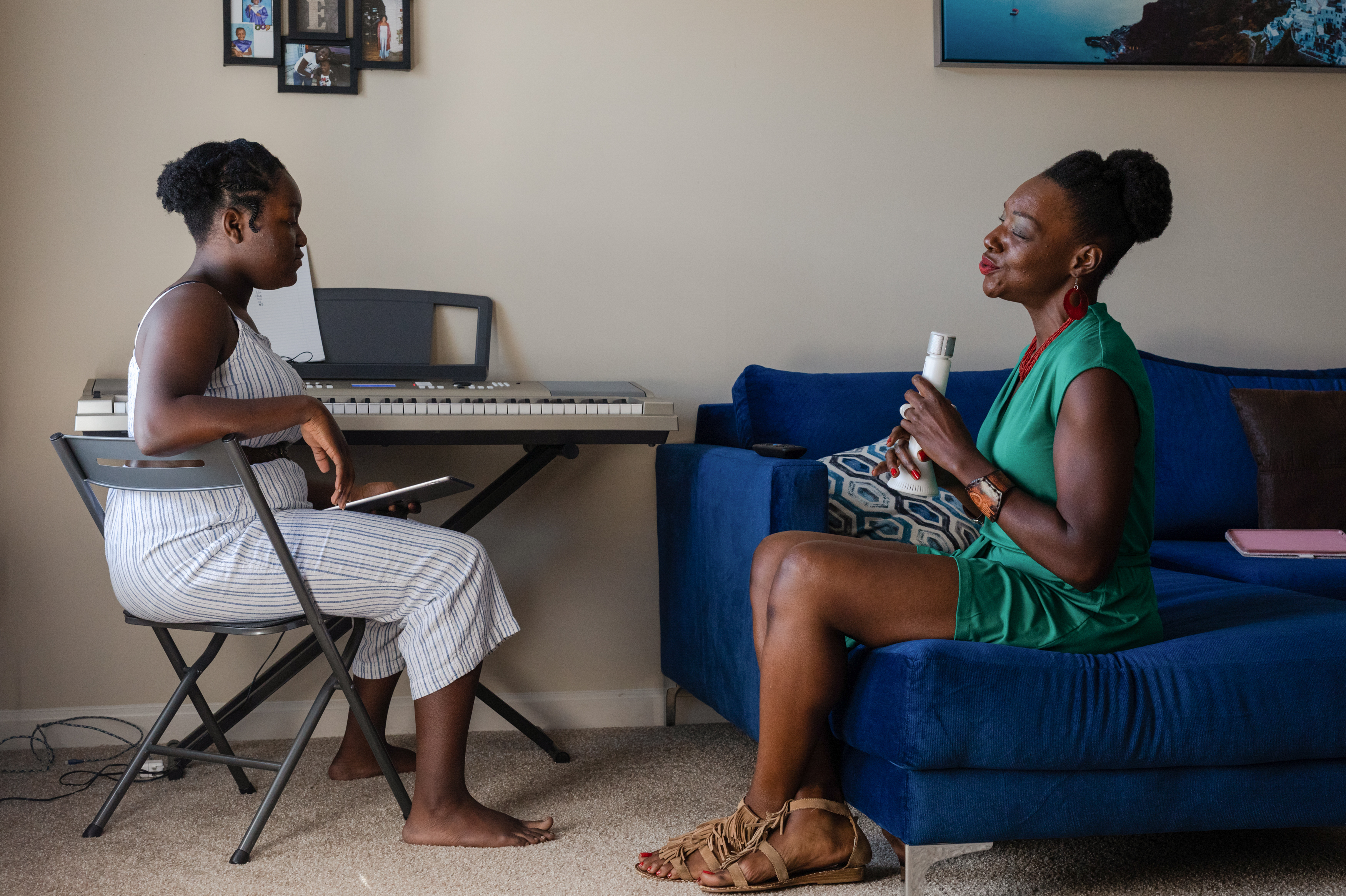 Terri Logan (right) practices music with her daughter, Amari Johnson (left), at their home in Spartanburg, S.C. When Logan's daughter was born premature, the medical bills started pouring in and stayed with her for years. Then, a few months ago, she discovered a nonprofit had paid off her debt. (Juan Diego Reyes for KHN and NPR)