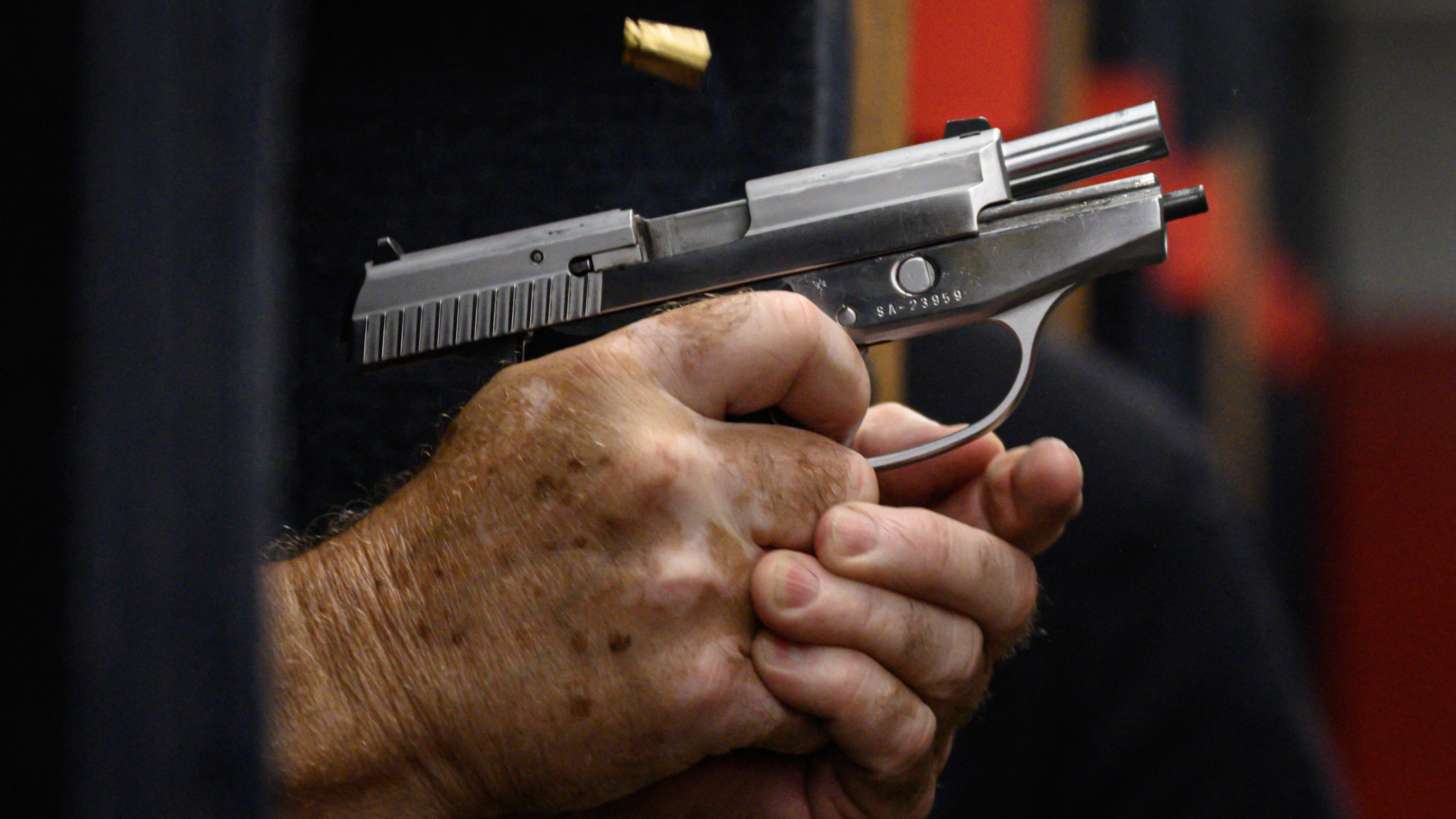 Shooting range owner John Deloca fires his pistol at his range in Queens, N.Y. (AFP via Getty Images)