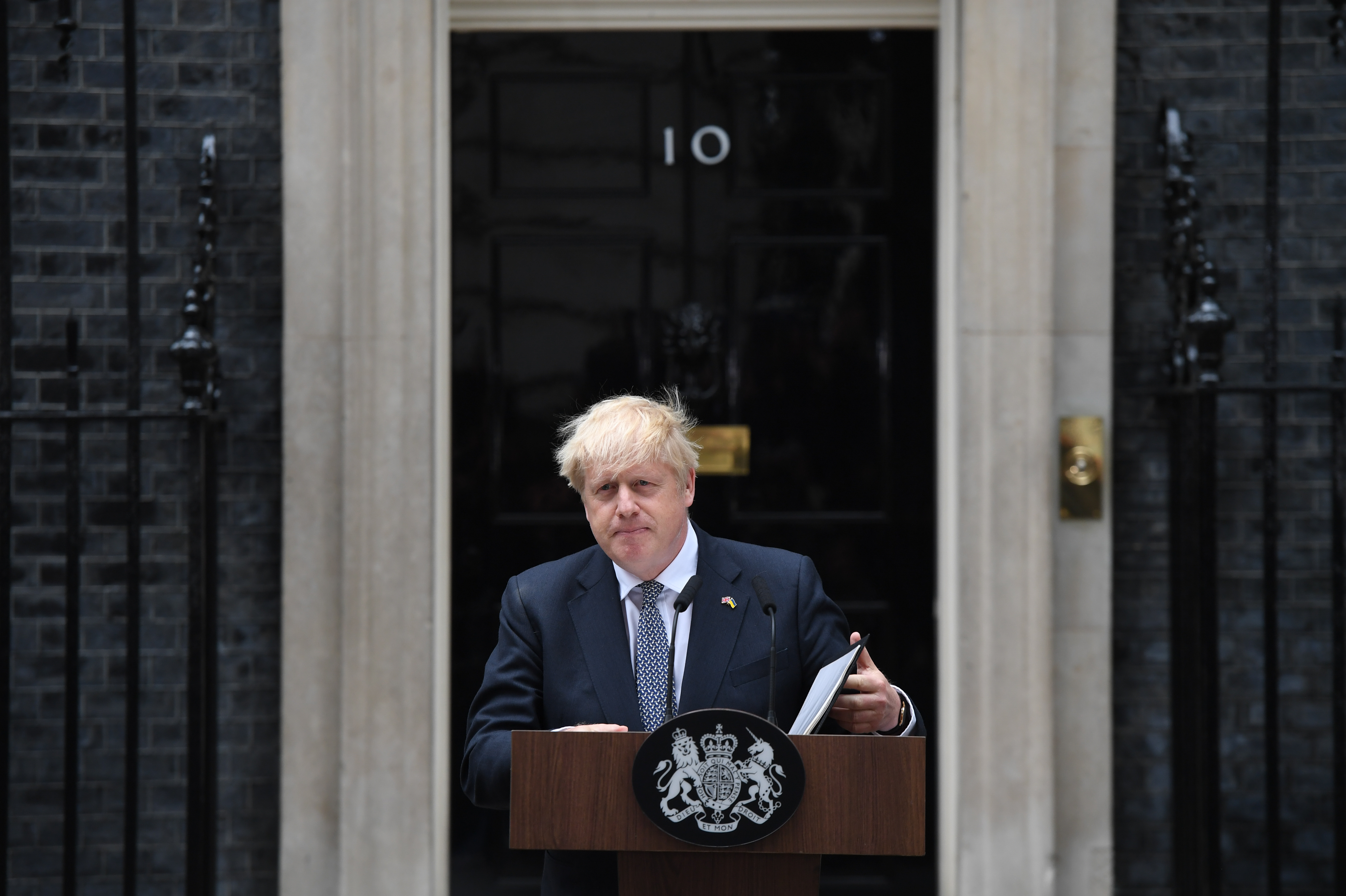 British Prime Minister Boris Johnson makes a resignation speech outside 10 Downing St. in London on Thursday. Johnson is bowing out after his government hemorrhaged dozens of ministers and junior aides, and members of his Cabinet told him he should step down. (Bloomberg via Getty Images)
