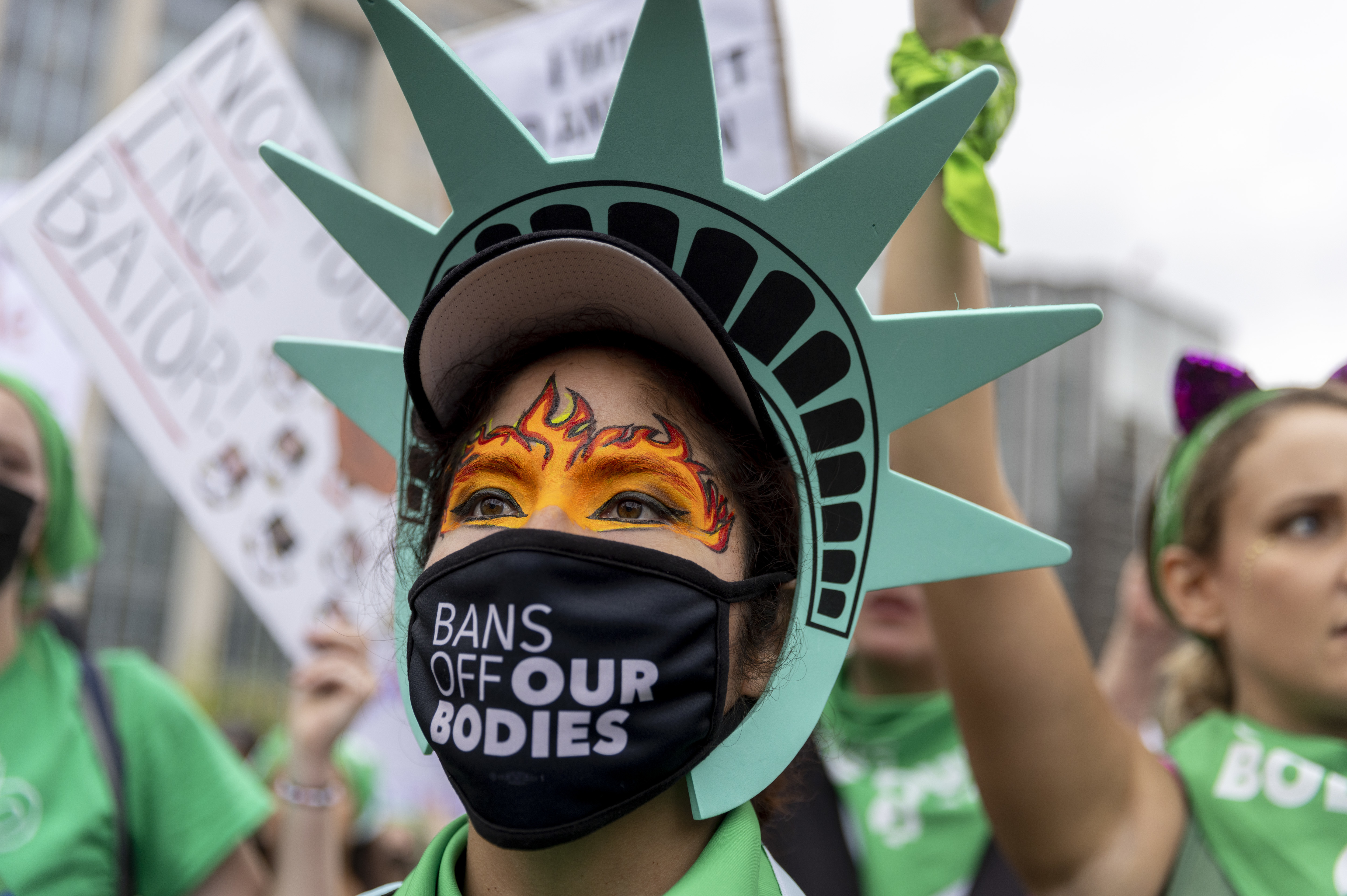 Sonia Glenn from Fairfax, Virginia wears a Statue of Liberty costume at the rally in Lafayette Square park before the Women's March in Washington, D.C., to protest the Supreme Court's overturning of Roe v. Wade. (Tyrone Turner/WAMU for NPR)