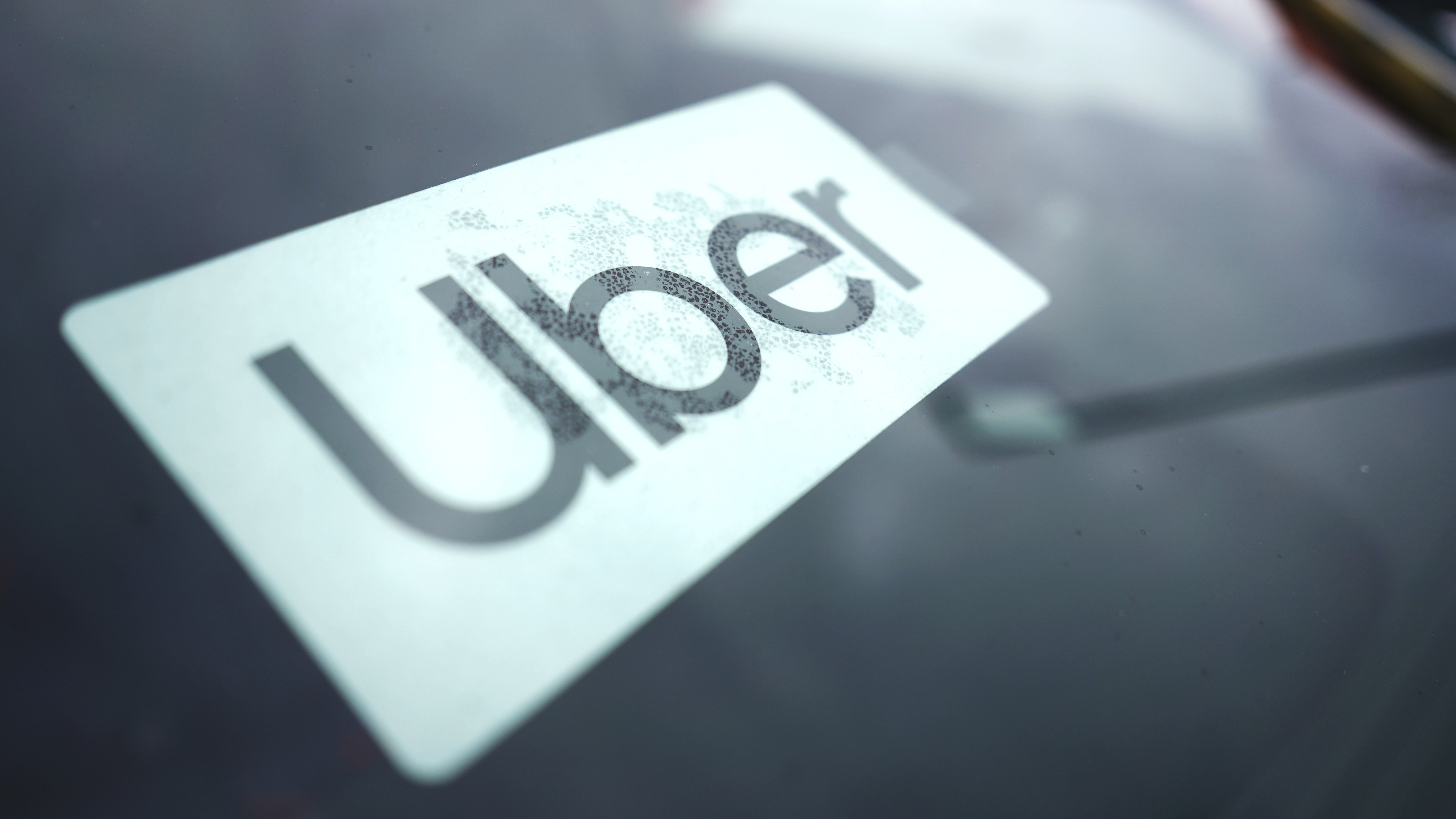 An Uber sign is displayed inside a car in Palatine, Ill., Thursday, Feb. 10, 2022.