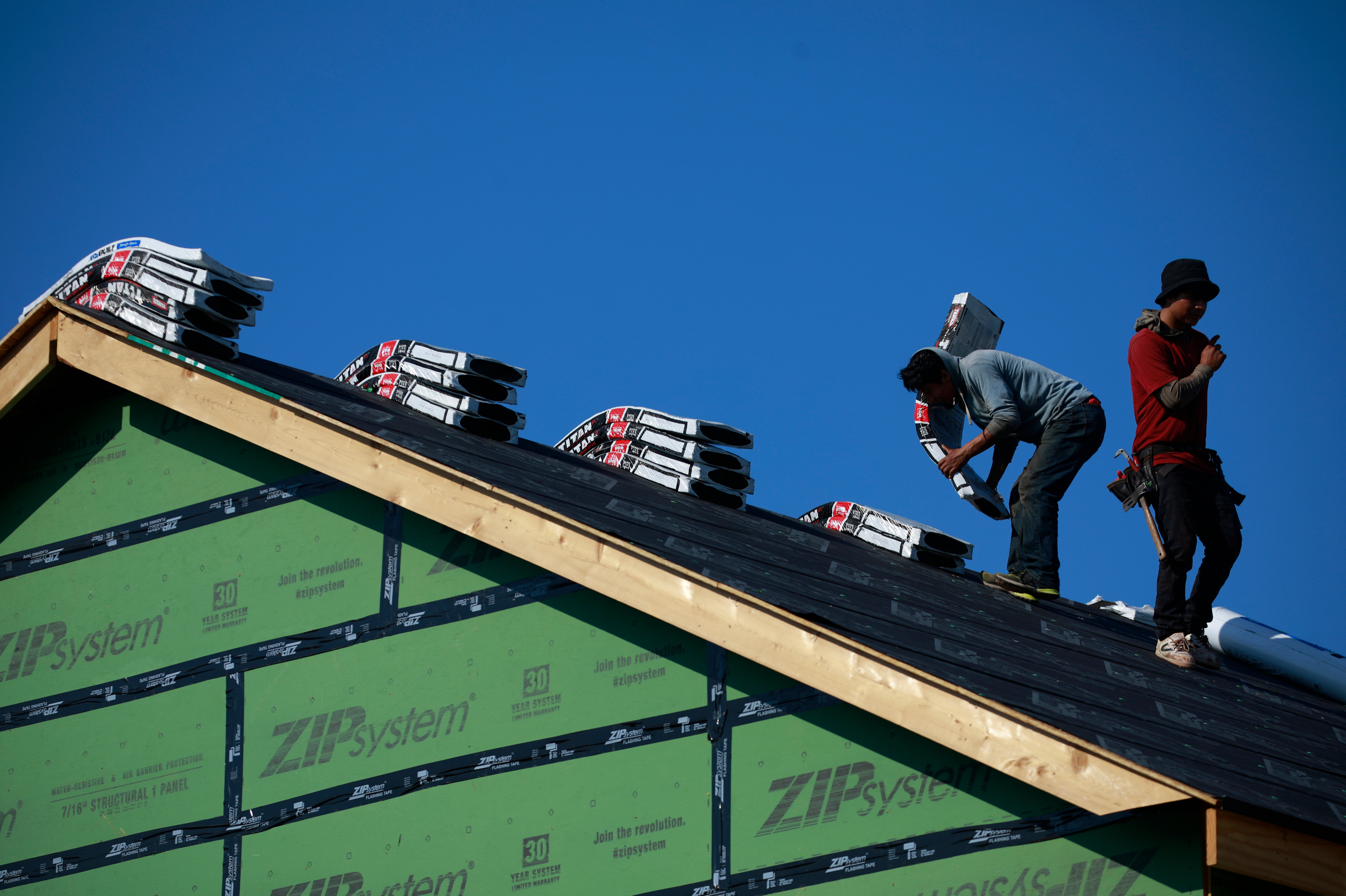 Contractors work on the roof of a house under construction in Louisville, Ky. A new study shows the U.S. is 3.8 million homes short of meeting housing needs. (Bloomberg via Getty Images)