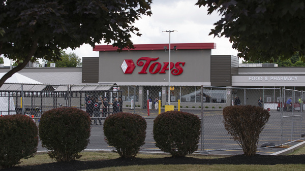 People stand in the parking lot of the Tops Friendly Market last week in Buffalo, N.Y., last week.