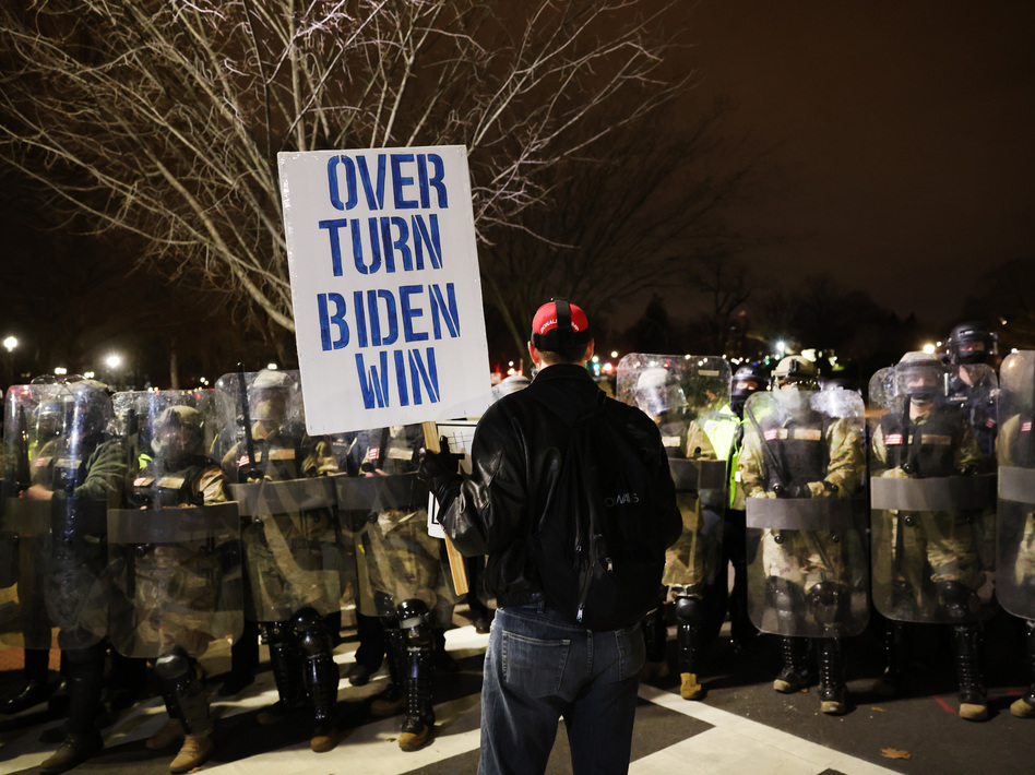 Members of the National Guard and the Washington D.C. police keep a small group of demonstrators away from the Capital after thousands of Donald Trump supporters stormed the United States Capitol building following a 'Stop the Steal' rally on January 06, 2021 in Washington, DC.