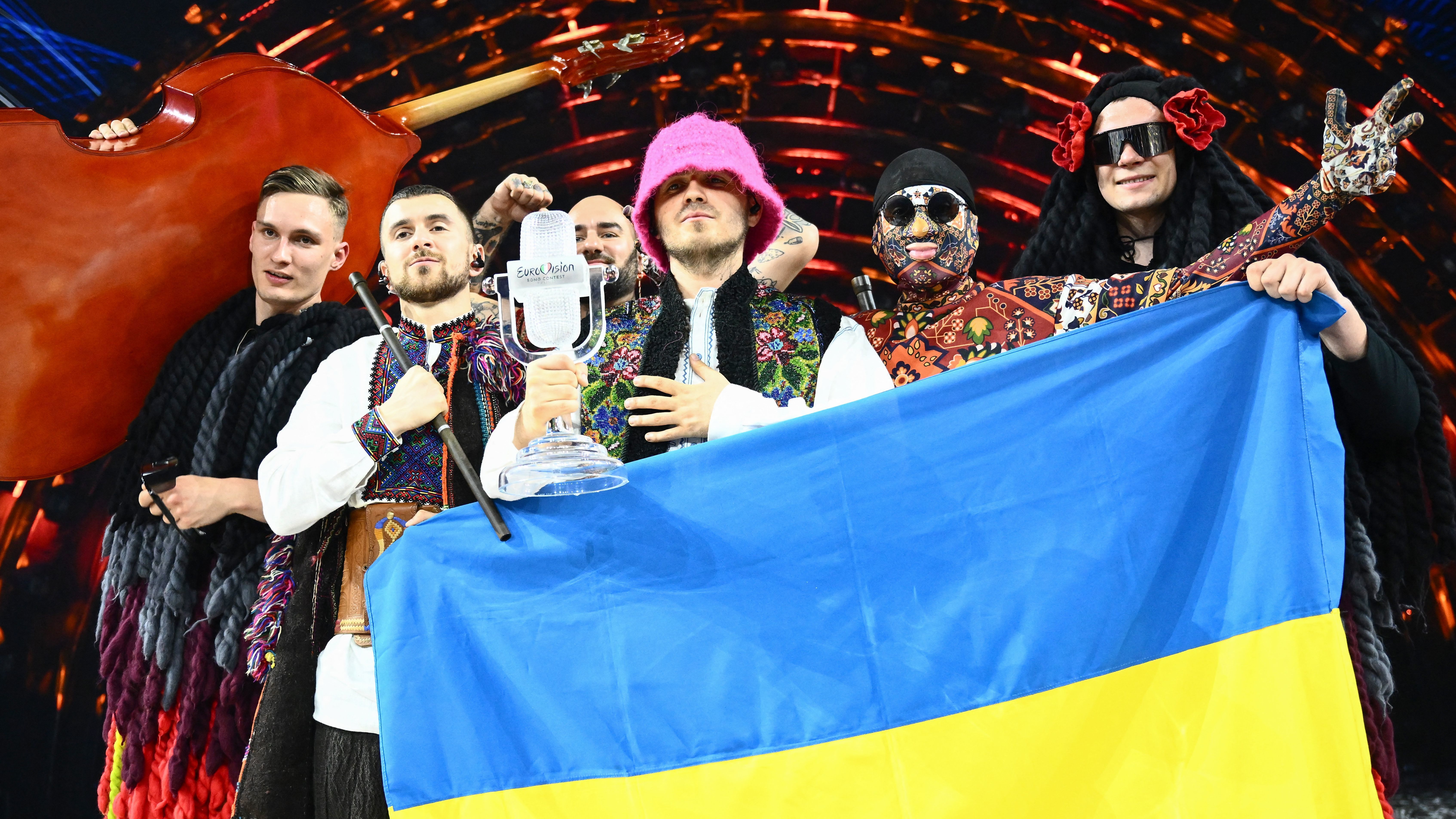 Members of the Ukrainian band Kalush Orchestra pose onstage after winning the Eurovision Song Contest on May 14 in Turin, Italy. The winning country typically hosts the next year