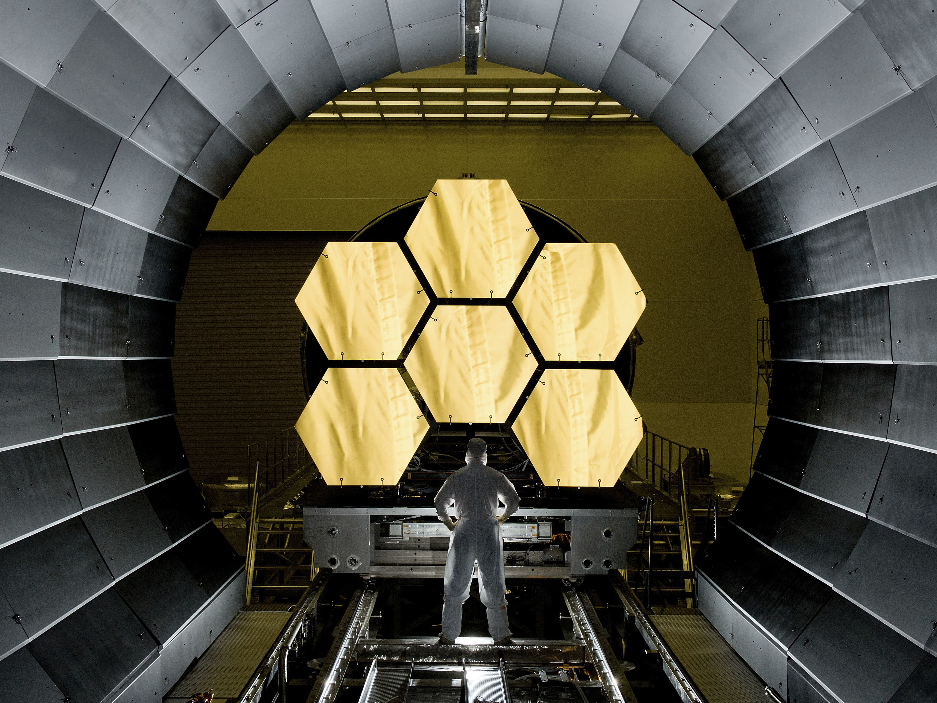 Ernie Wright stands near the James Webb Space Telescope mirrors as they sit just outside the testing chamber in the x-ray calibration facility at MSFC. (Getty Images)