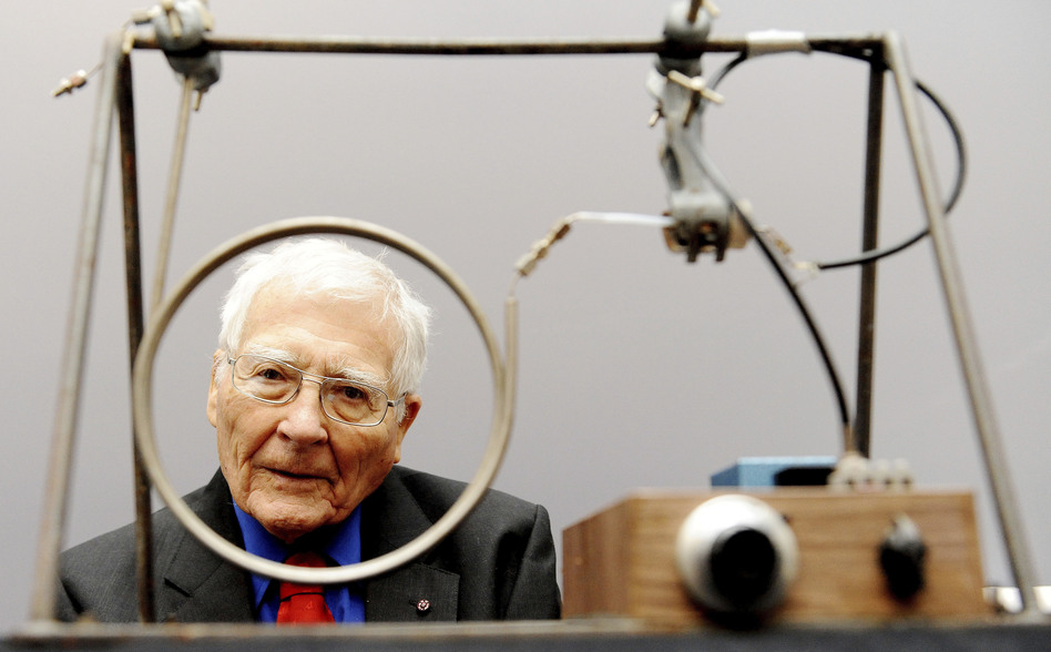 Scientist and inventor James Lovelock poses with one of his early inventions, a homemade gas chromatography device, used for measuring gas and molecules present in the atmosphere, at a science museum in London.