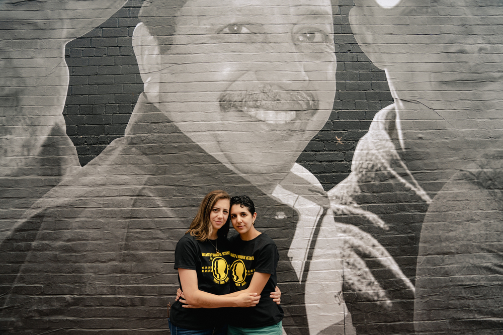 Alexandra Forseth (left) and Gabriela Zambrano Hill stand in front of a mural of their father, Alirio Jose<strong> </strong>Zambrano, at an event hosted by the Bring Our Families Home Campaign in Washington, D.C., on July 20. The State Department says both their father and an uncle, Jose Luis Zambrano, are wrongfully detained in Venezuela. (Shuran Huang for NPR)