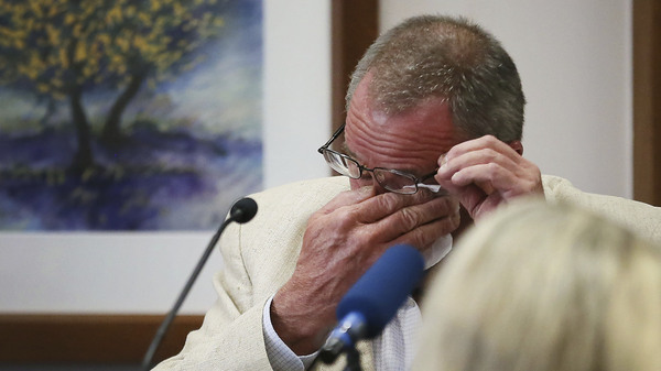 Neil Heslin, father of 6-year-old Sandy Hook shooting victim Jesse Lewis, becomes emotional while testifying in the trial of Alex Jones on Tuesday in Austin, Texas.