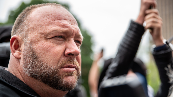 Infowars founder Alex Jones listens to a supporter at the Texas State Capital building in April 2020 in Austin, Texas.