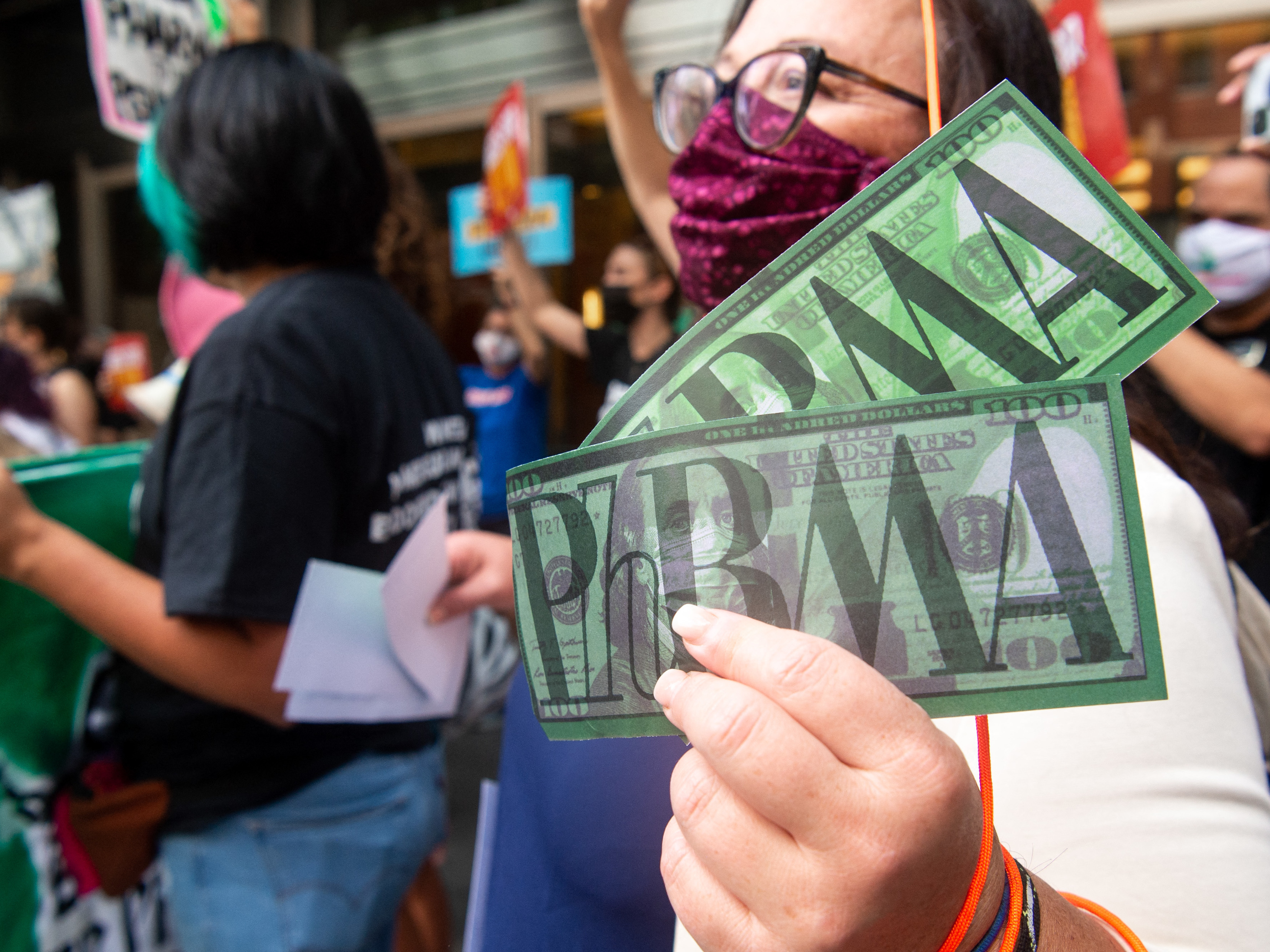 Demonstrators outside PhRMA headquarters in Washington, D.C., protest lobbying by pharmaceutical companies to keep Medicare from negotiating lower prescription drug prices. (AFP via Getty Images)