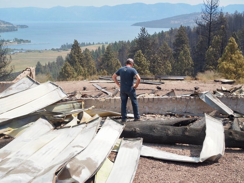 Steve Holett surveys the aftermath of the Elmo 2 Fire at his property, where he had spent the last 18 months building a home. (Lisa Holett)