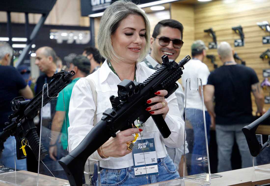 Brazilian soldiers search a man looking for guns at the entrance