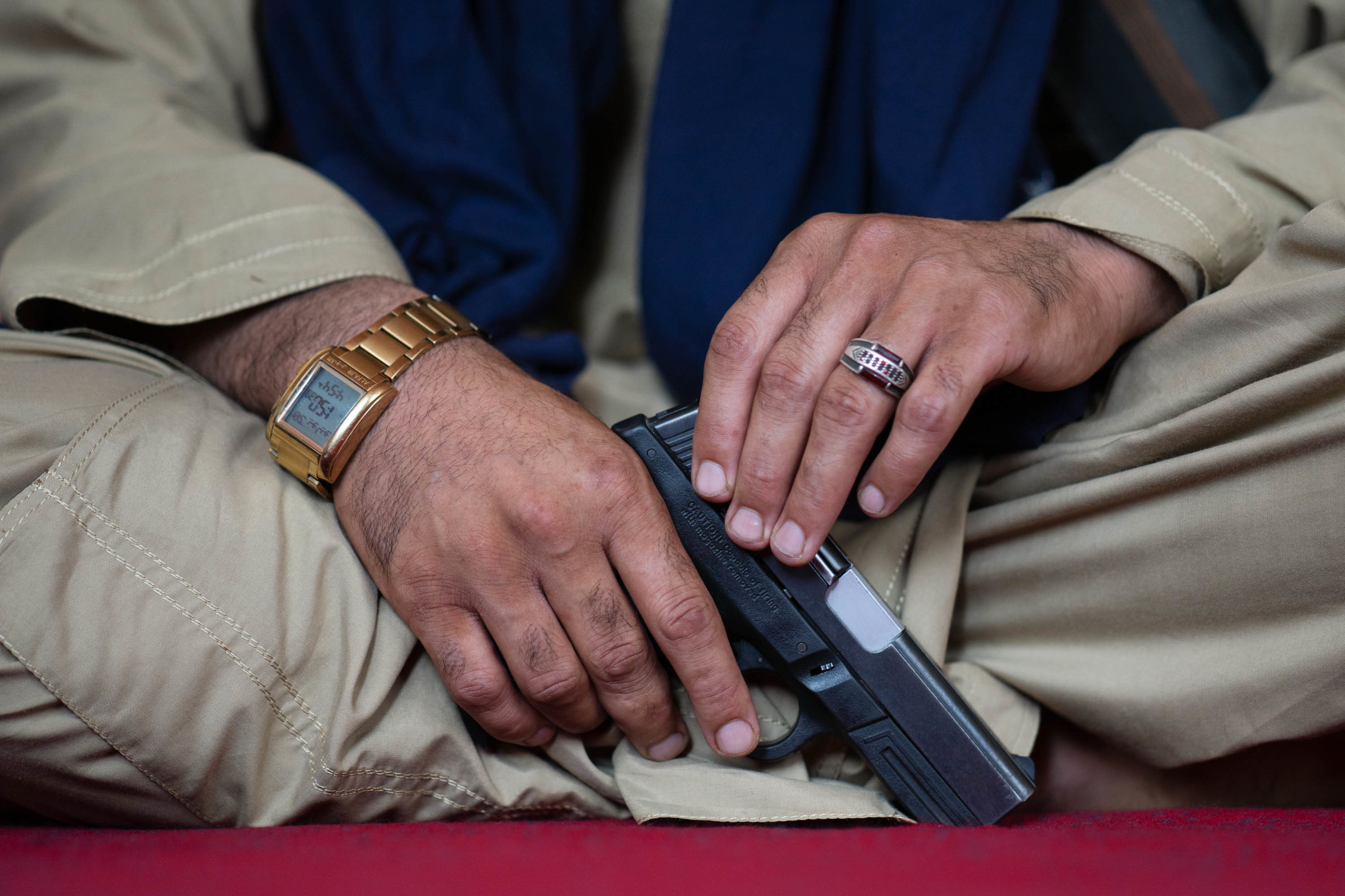 Afghans in a battle-scarred valley welcomed Taliban rule, but expect more 5 Wahadat holds a Smith & Wesson pistol.