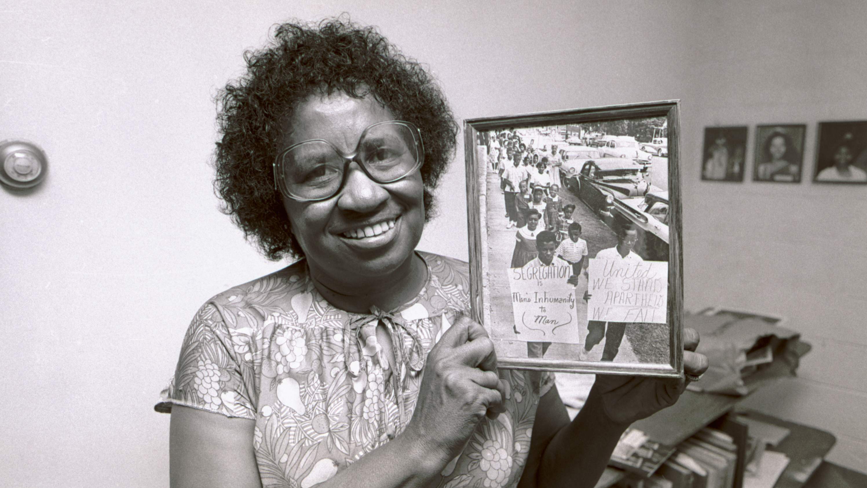 Civil rights leader Clara Luper poses with a photograph from her scrapbooks at a community center in Oklahoma City, Okla., in August 1983.