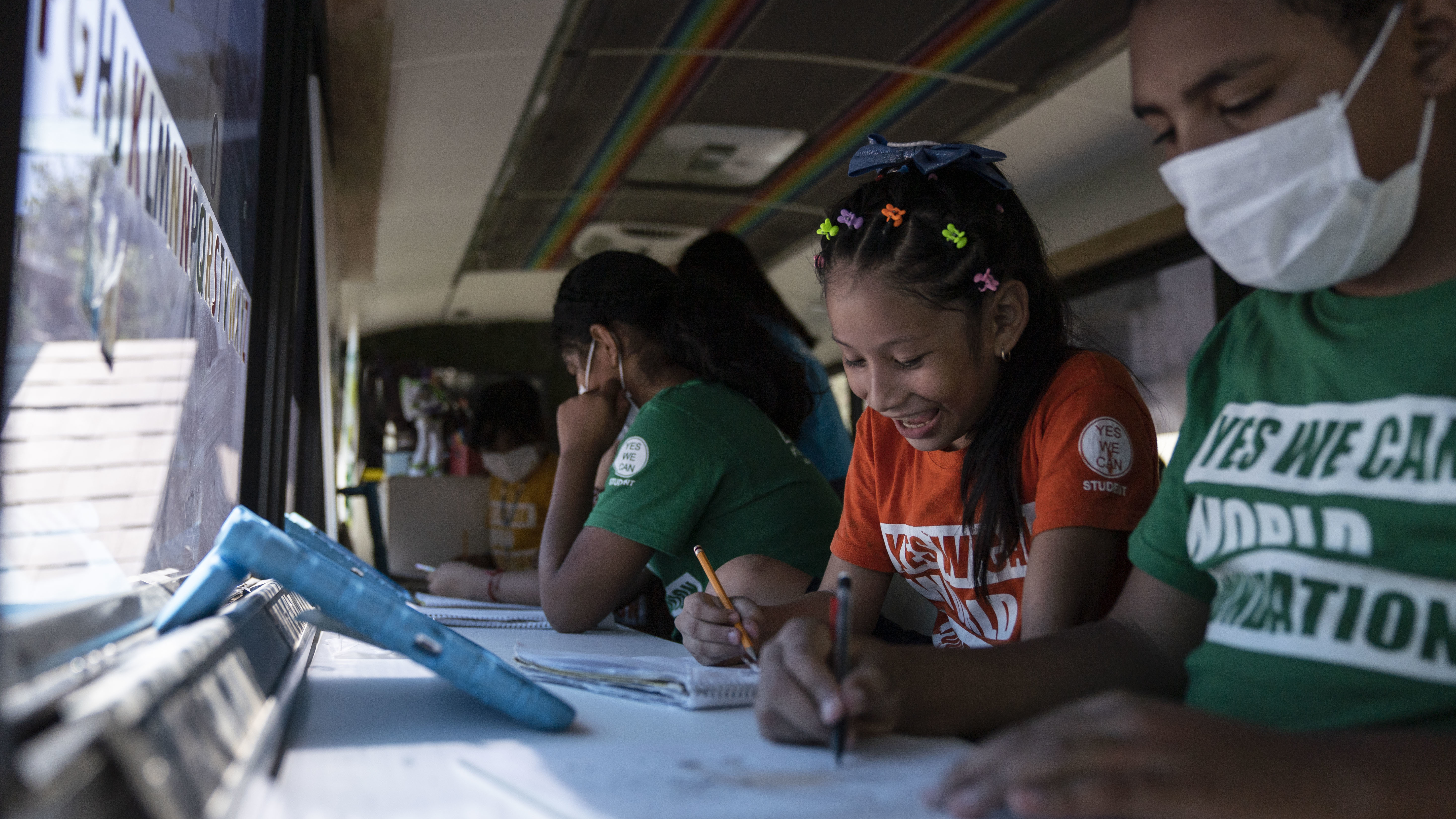 In converted buses and tin-roof sheds, migrant students get a lesson in hope