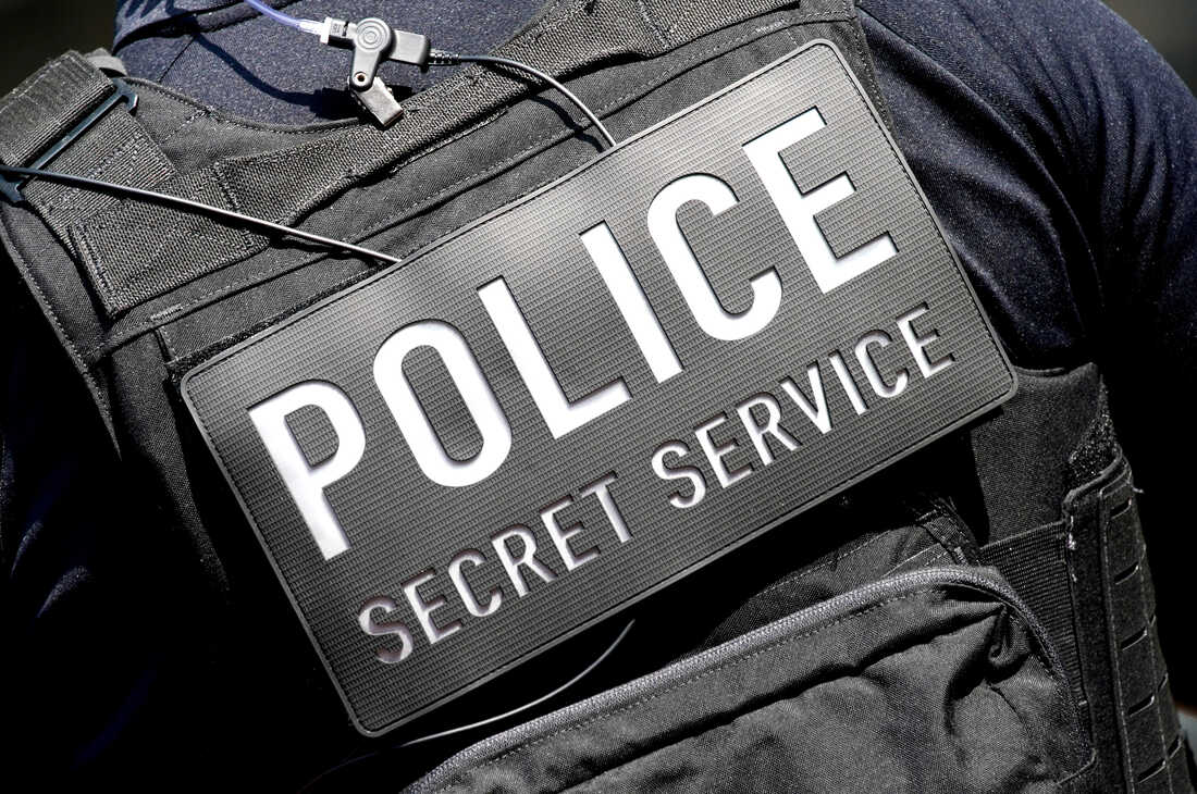 A closeup of a secret service vest