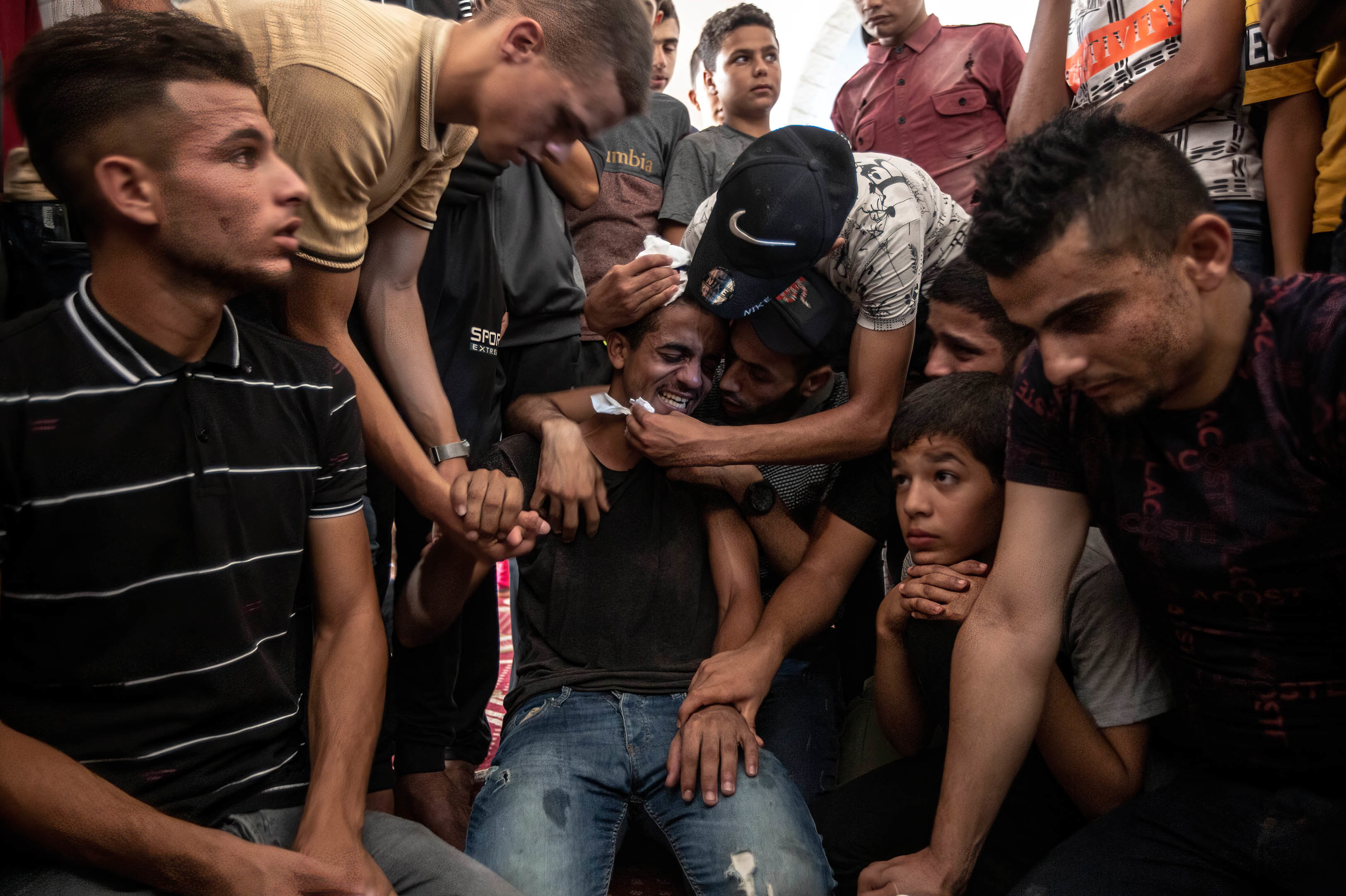 Relatives of Lian al-Shaer, a 10-year-old Palestinian girl, mourn during her funeral ceremony in Khan Yunis in the southern Gaza Strip on Aug. 11. Lian died of injuries sustained during the violence between Israel and Islamic Jihad. (SOPA Images/LightRocket via Getty Images)