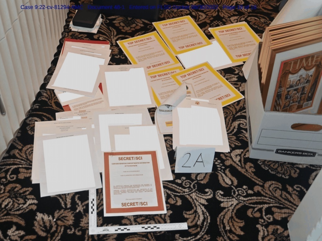 This image contained in a court filing by the Department of Justice on Aug. 30, and redacted by in part by the FBI, shows a photo of documents seized during the Aug. 8 search by the FBI of former President Donald Trump's Mar-a-Lago estate in Florida. (Department of Justice)