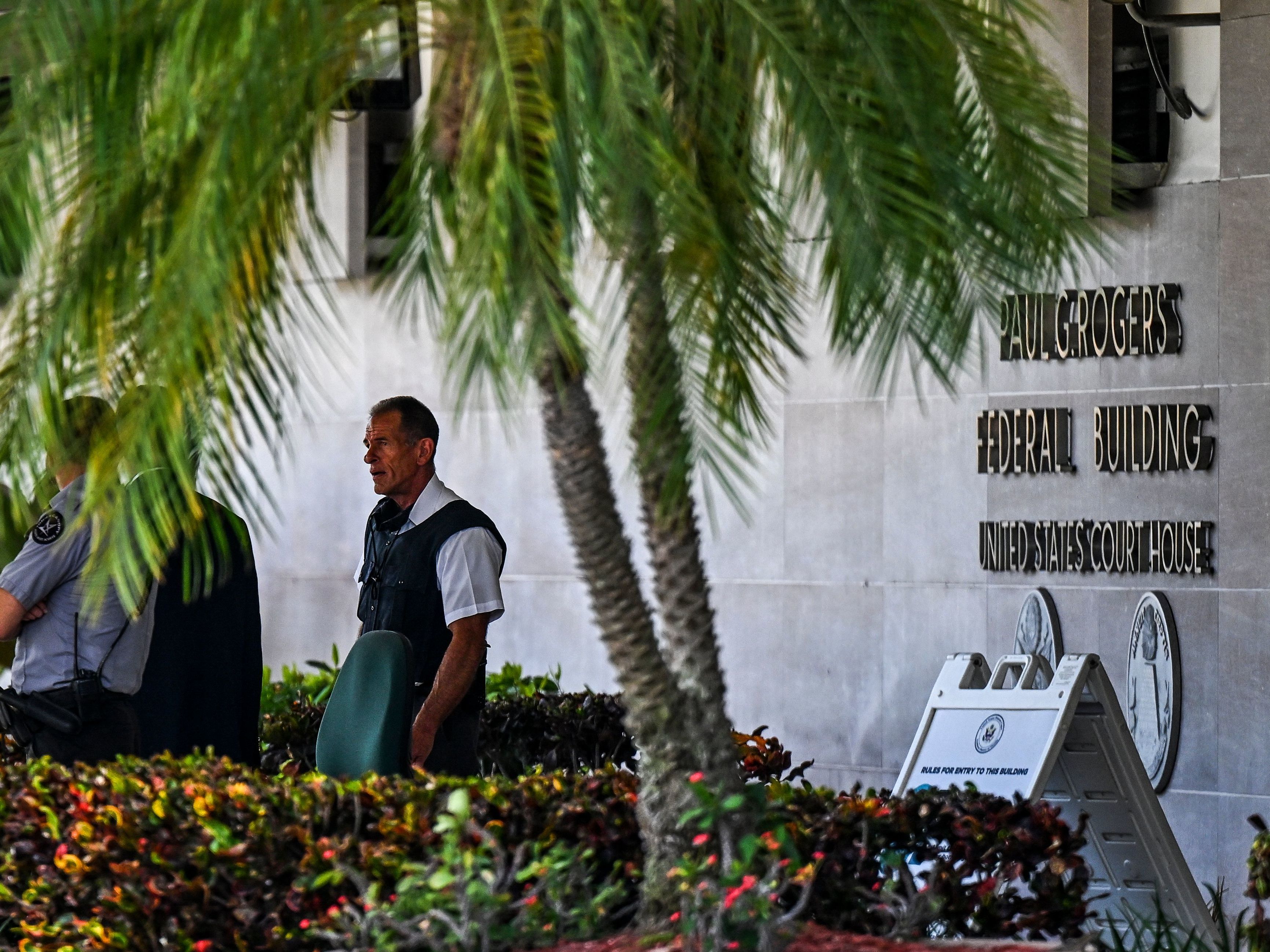 Security officers guard the entrance to the Paul G. Rogers Federal Building & Courthouse as the court holds a hearing to determine if the affidavit used by the FBI as justification for last week's search of Trump's Mar-a-Lago estate should be unsealed, at the U.S. District Courthouse for the Southern District of Florida in West Palm Beach on Aug. 18. (AFP via Getty Images)