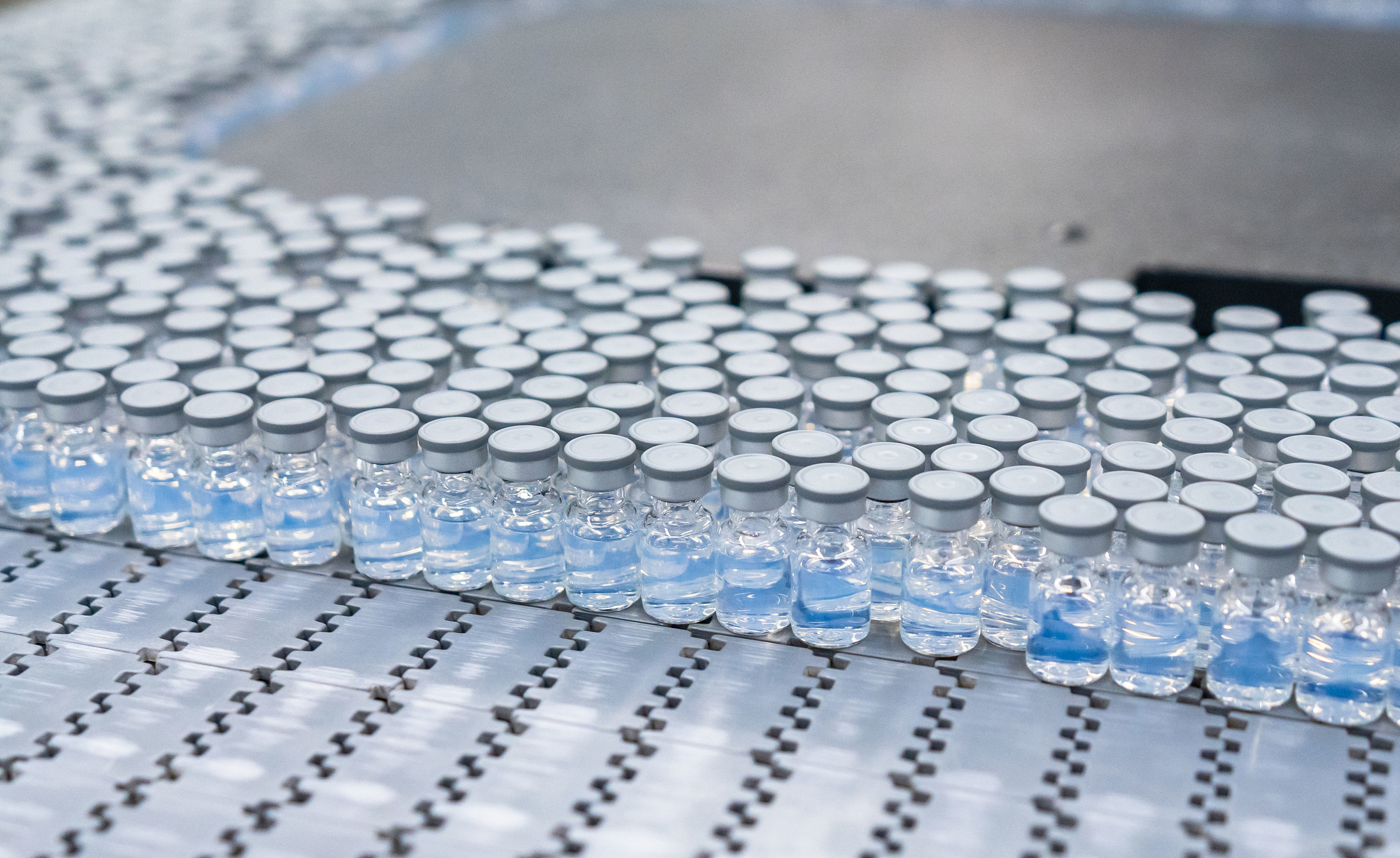 Vials of the reformulated Pfizer-BioNTech COVID-19 booster move through production at a plant in Kalamazoo, Mich. (Pfizer Inc.)