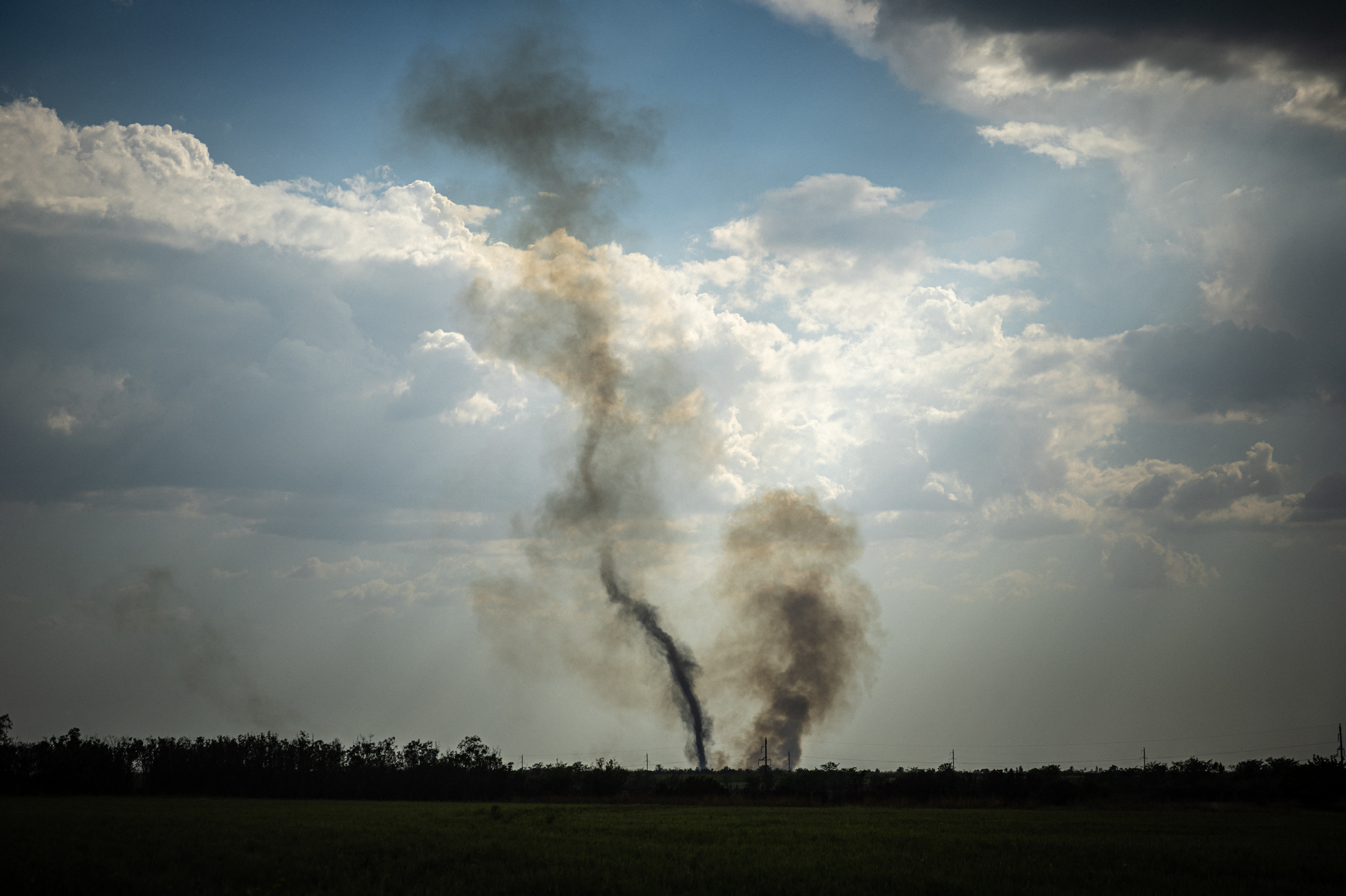 Black smoke rises at the front line in southern Ukraine's Mykolaiv Oblast on Aug. 30 amid Russia's military invasion of the country. Ukraine has begun a major counteroffensive to retake areas in the south that Russia seized early in the war. (AFP via Getty Images)