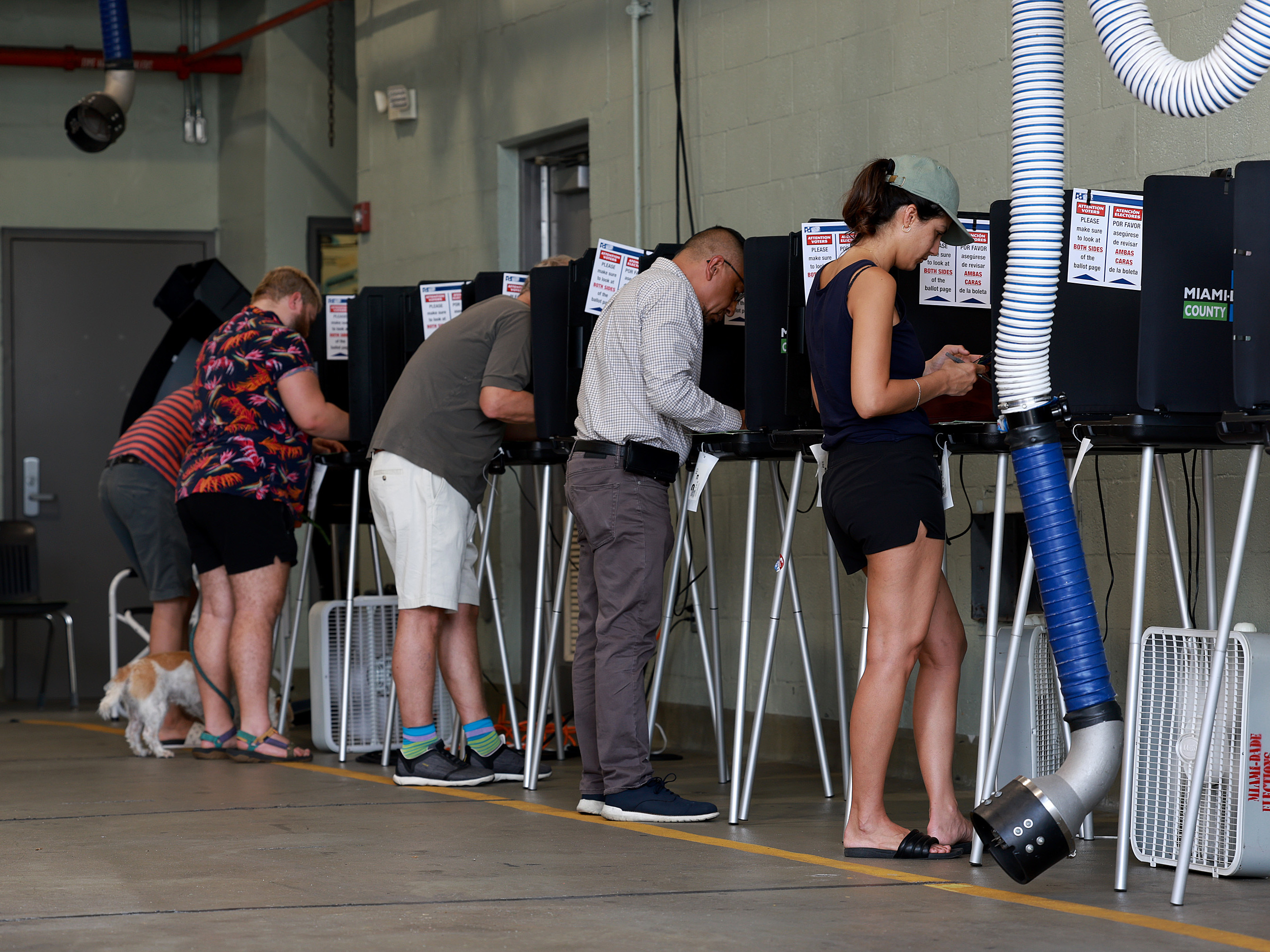 Voters cast their ballots at a polling station set up in a fire station on Aug. 23 in Miami Beach, Fla. (Getty Images)