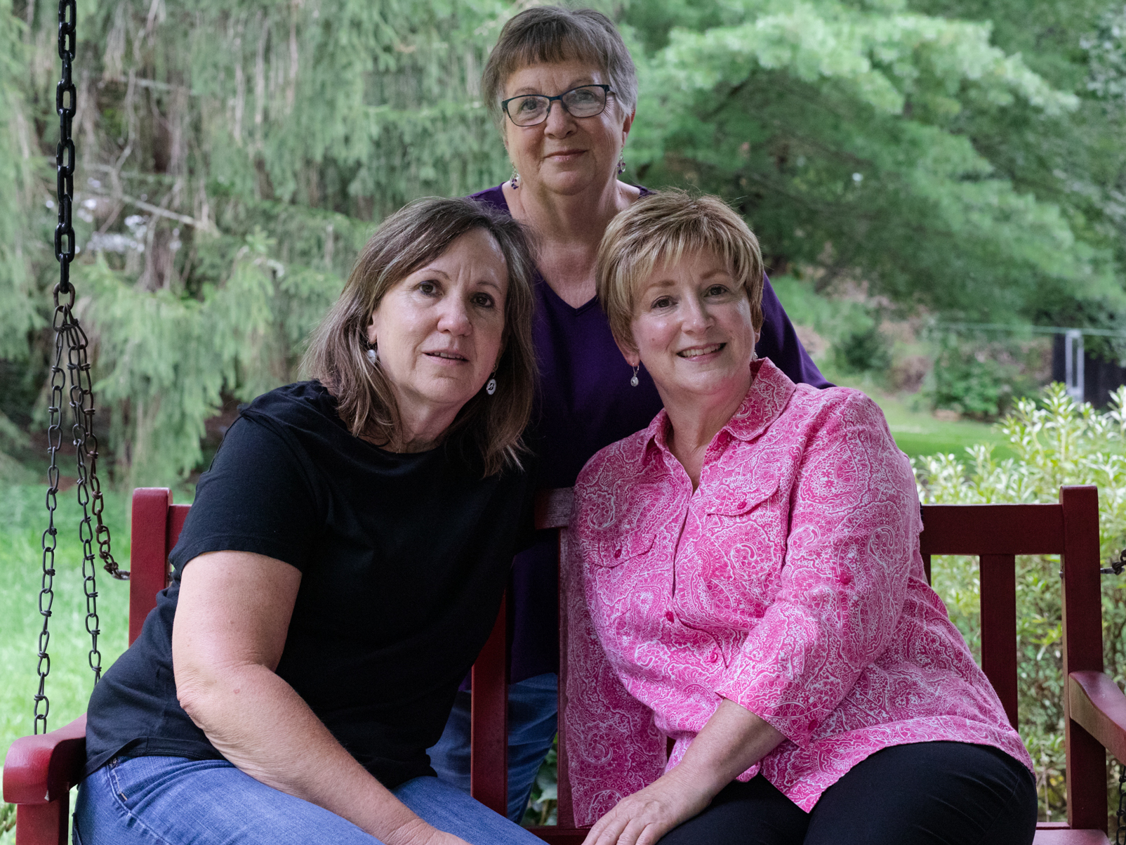 Karen Douthitt (left) and her two of her older sisters, Susie Gilliam (center), and June Ward (right) each took a test for the genetic mutation presenilin 1 after their mom got Alzheimer's disease in her early 60s. Each child of a parent with this mutation has a 50% chance of inheriting it. (Juan Diego Reyes for NPR)