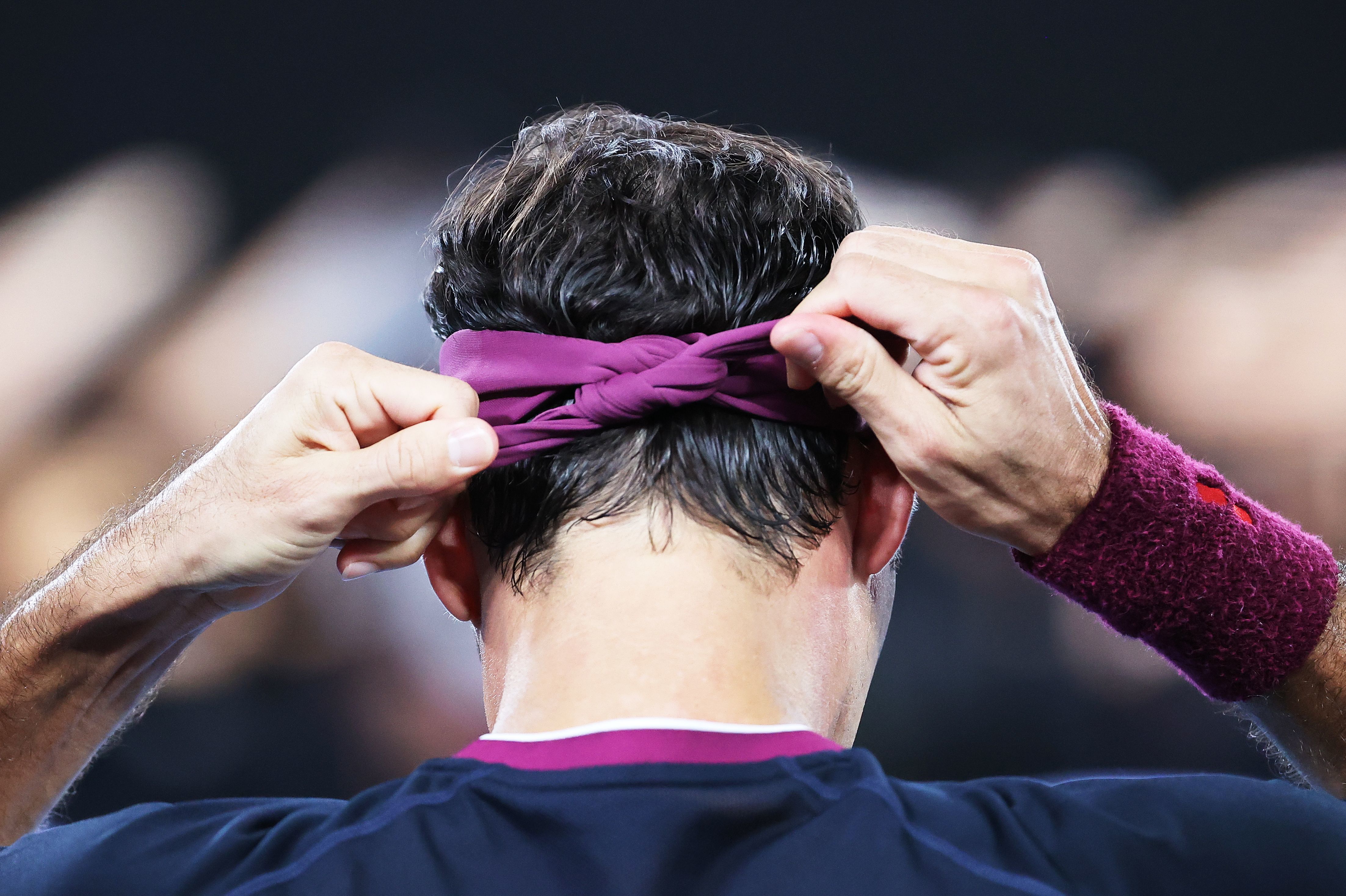 January 30, 2020: Switzerland's Roger Federer ties his head band during a break in his men's singles semi-final match against Serbia's Novak Djokovic on day eleven of the Australian Open tennis tournament in Melbourne.