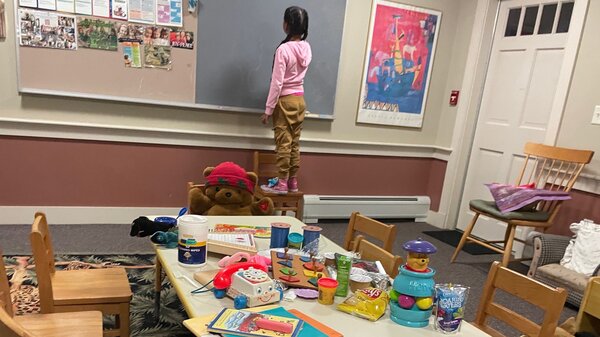 A young girl is shown staying at a shelter on Martha's Vineyard, Mass., after she and dozens of other migrants arrived by plane unannounced Wednesday.