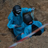 Outside a liberated Ukrainian town, inspectors search for evidence of war crimes