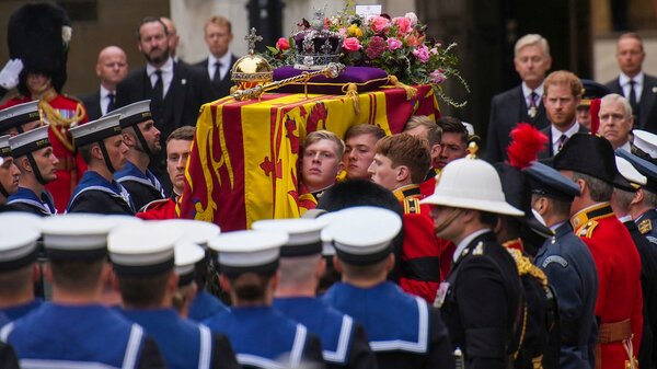  A Bearer Party of The Queen's Company, 1st Battalion Grenadier Guards, places the coffin of Queen Elizabeth II, draped in the Royal Standard, onto the State Gun Carriage of the Royal Navy outside Westminster Hall, at the Palace of Westminster in London on Monday.