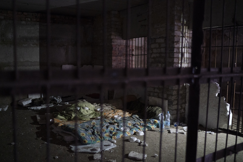 Bedding and sleeping bags in a basement where Ukrainian authorities say they found a torture cell used during the Russian occupation, in the retaken village of Kozacha Lopan on Saturday.