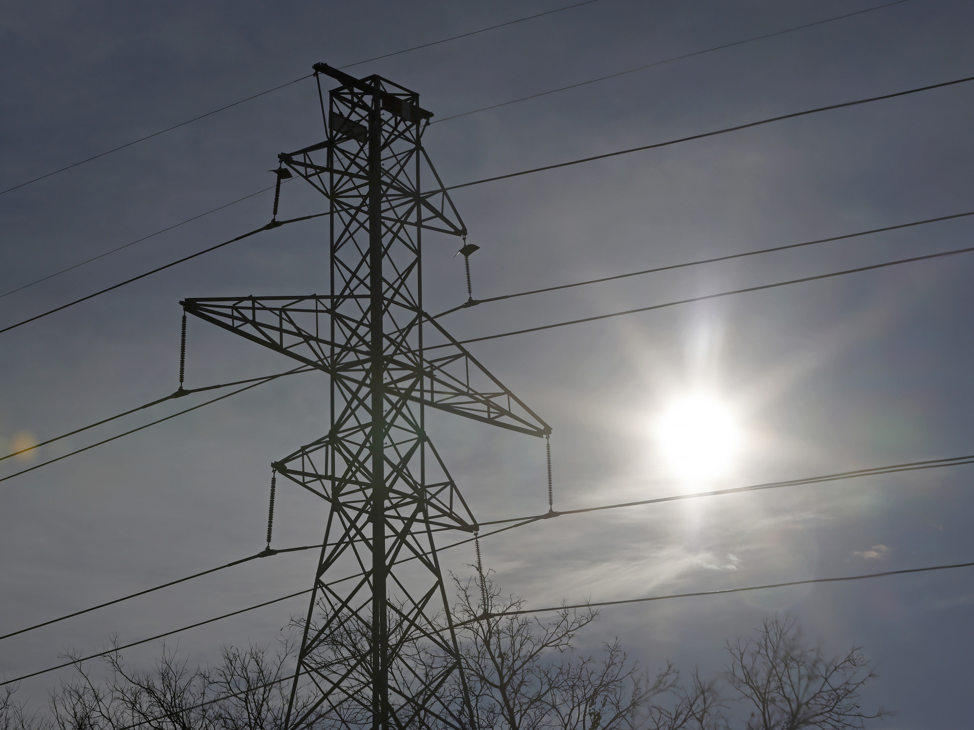 FORT WORTH, TX - FEBRUARY 16, 2021: Transmission towers support power lines above the frozen Clear Fork of the Trinity River in Fort Worth, Texas, after a snowstorm. (Photo credit: Ron Jenkins/Getty Images)