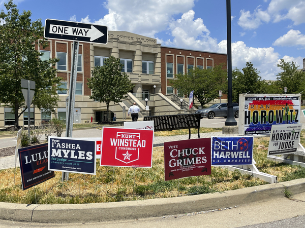 Campaign signs are posted outside a polling location on the first day of early voting on July 15 in Nashville, Tenn.