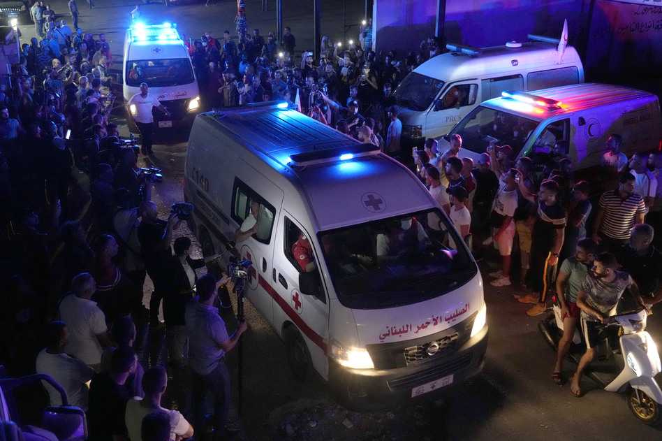Lebanese Red Cross ambulances, carrying the bodies of people who died in a boat sinking, cross between Lebanon and Syria on Friday.