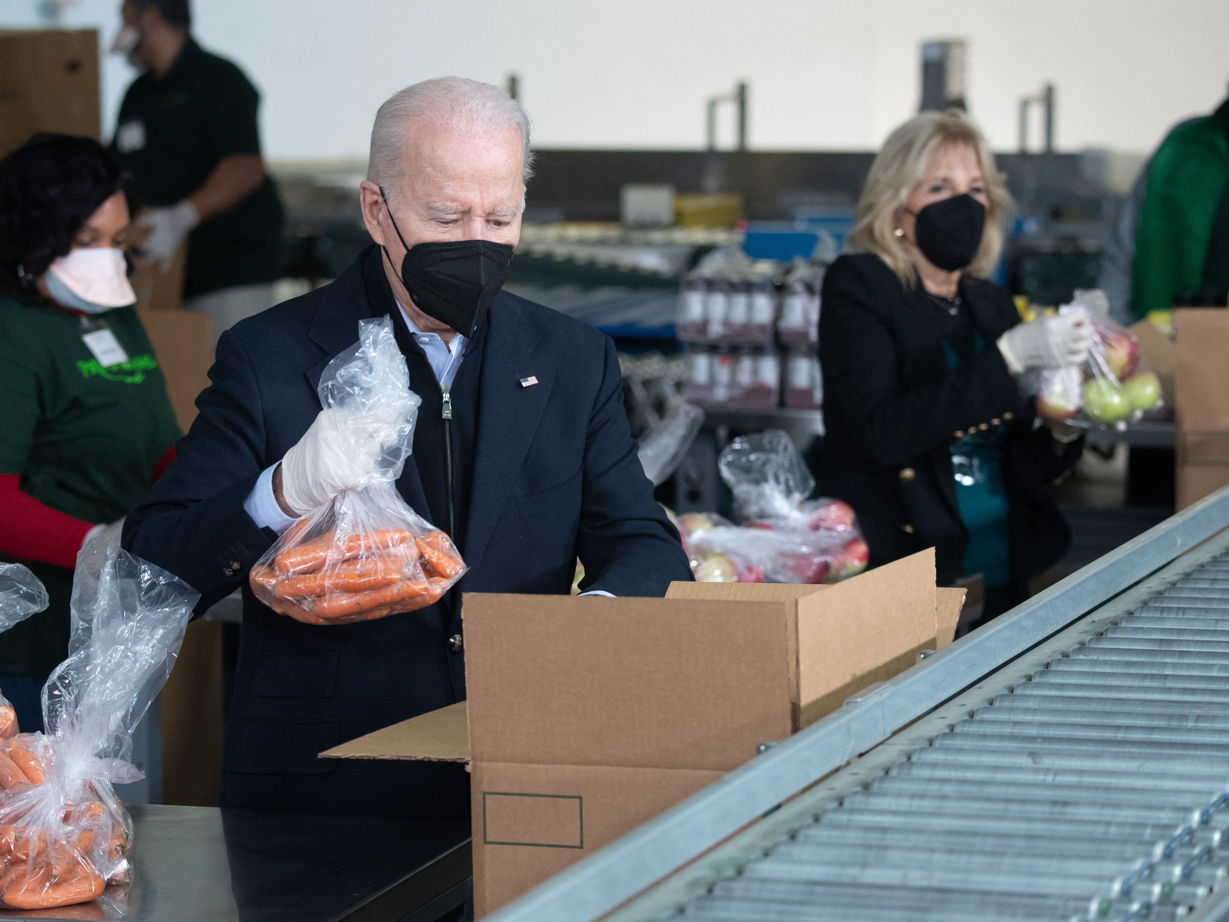 President Biden and first lady Jill Biden pack food boxes while volunteering on Martin Luther King, Jr., Day of Service in Philadelphia, Pennsylvania on Jan. 16, 2022. (AFP via Getty Images)