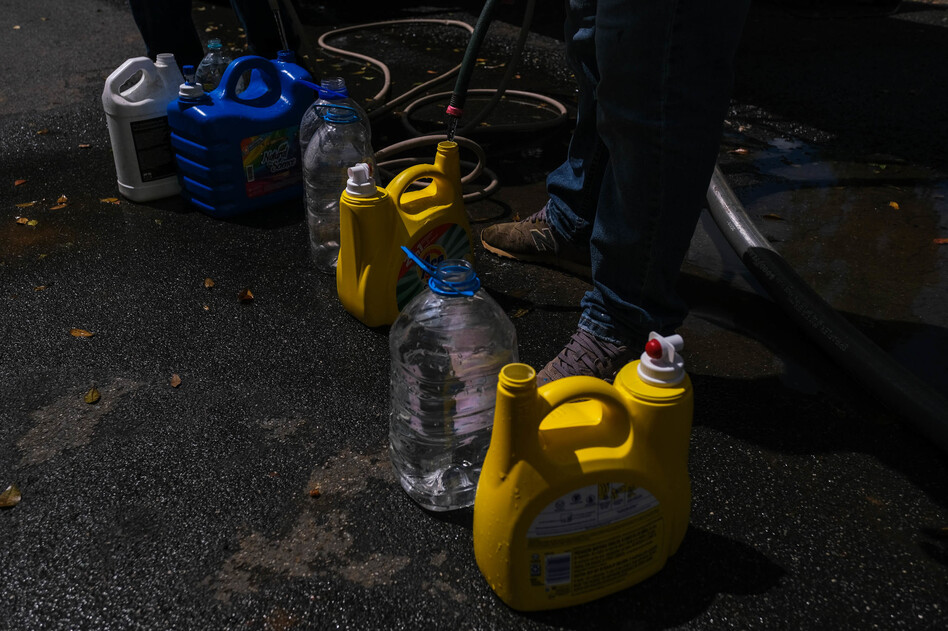 Residents of Orocovis line up at the Coliseum Jesus 'Tito' Colón to fill gallons, cisterns, and any kind of container with water.