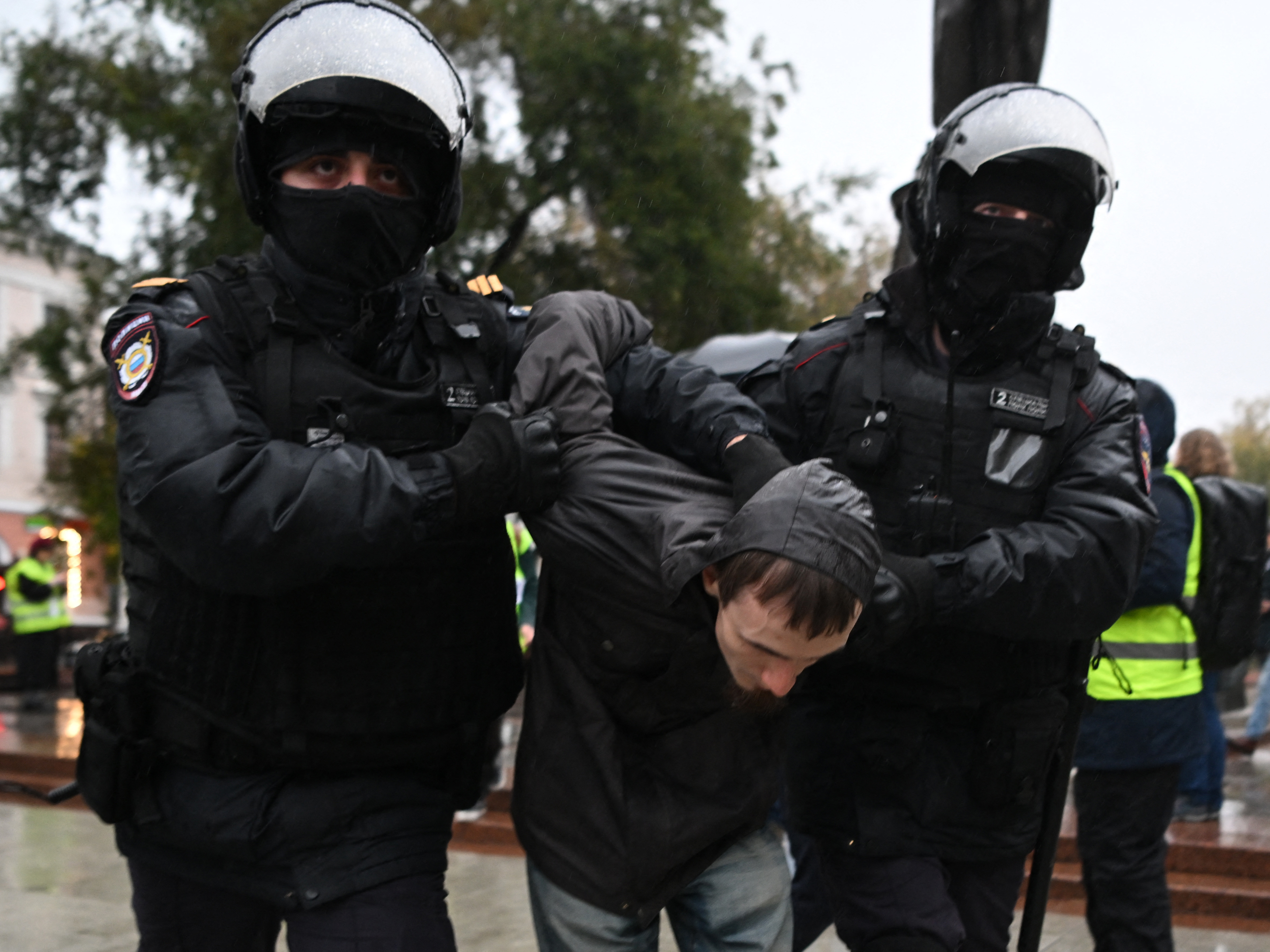 Police officers detain a man in Moscow on Saturday following calls to protest against the military draft announcement. (AFP via Getty Images)