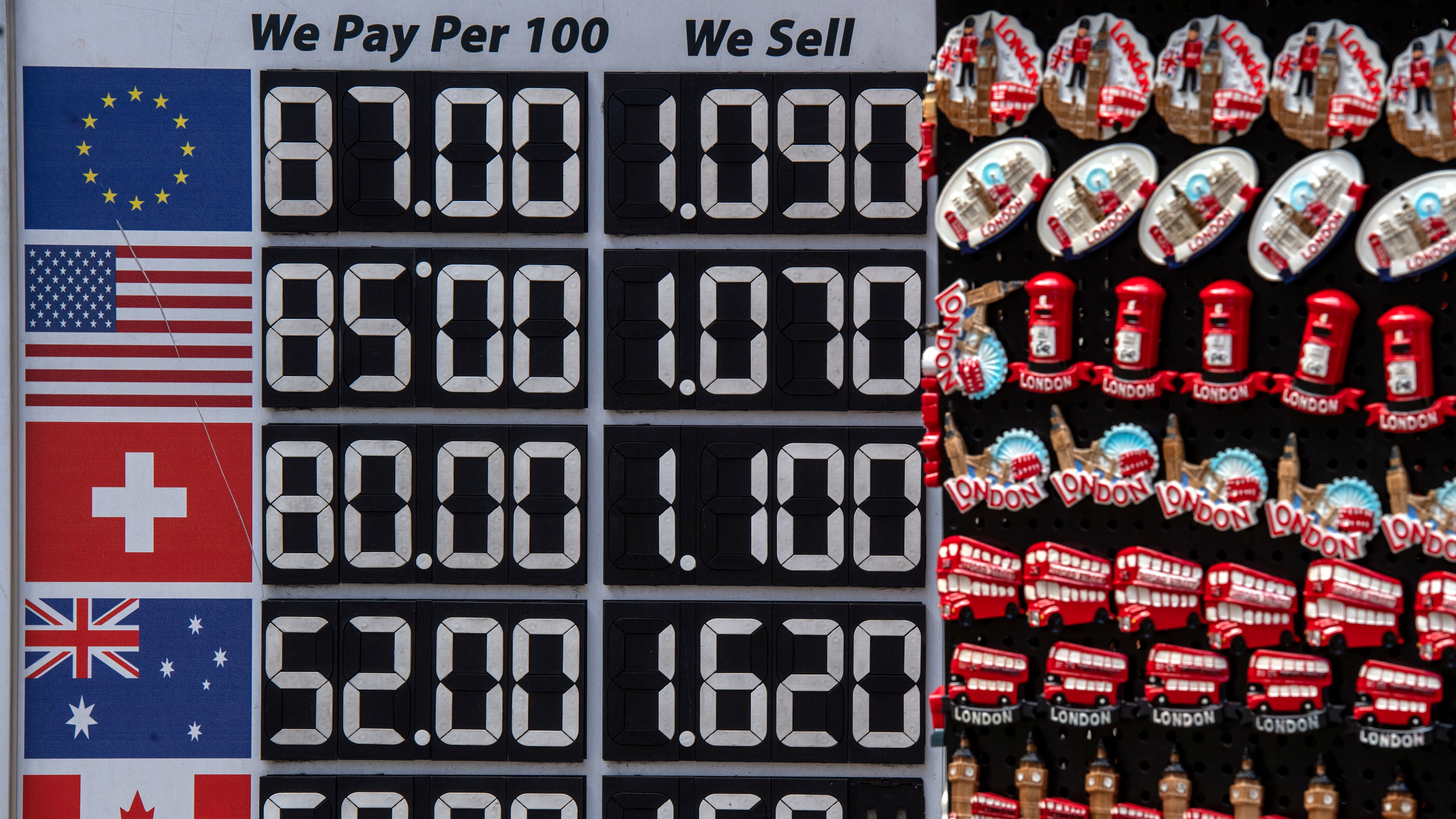 Exchange rates are advertised outside a Bureau de Change on Monday in London. The British pound fell against the U.S. dollar, fluctuating between $1.03 and $1.07 Monday morning.