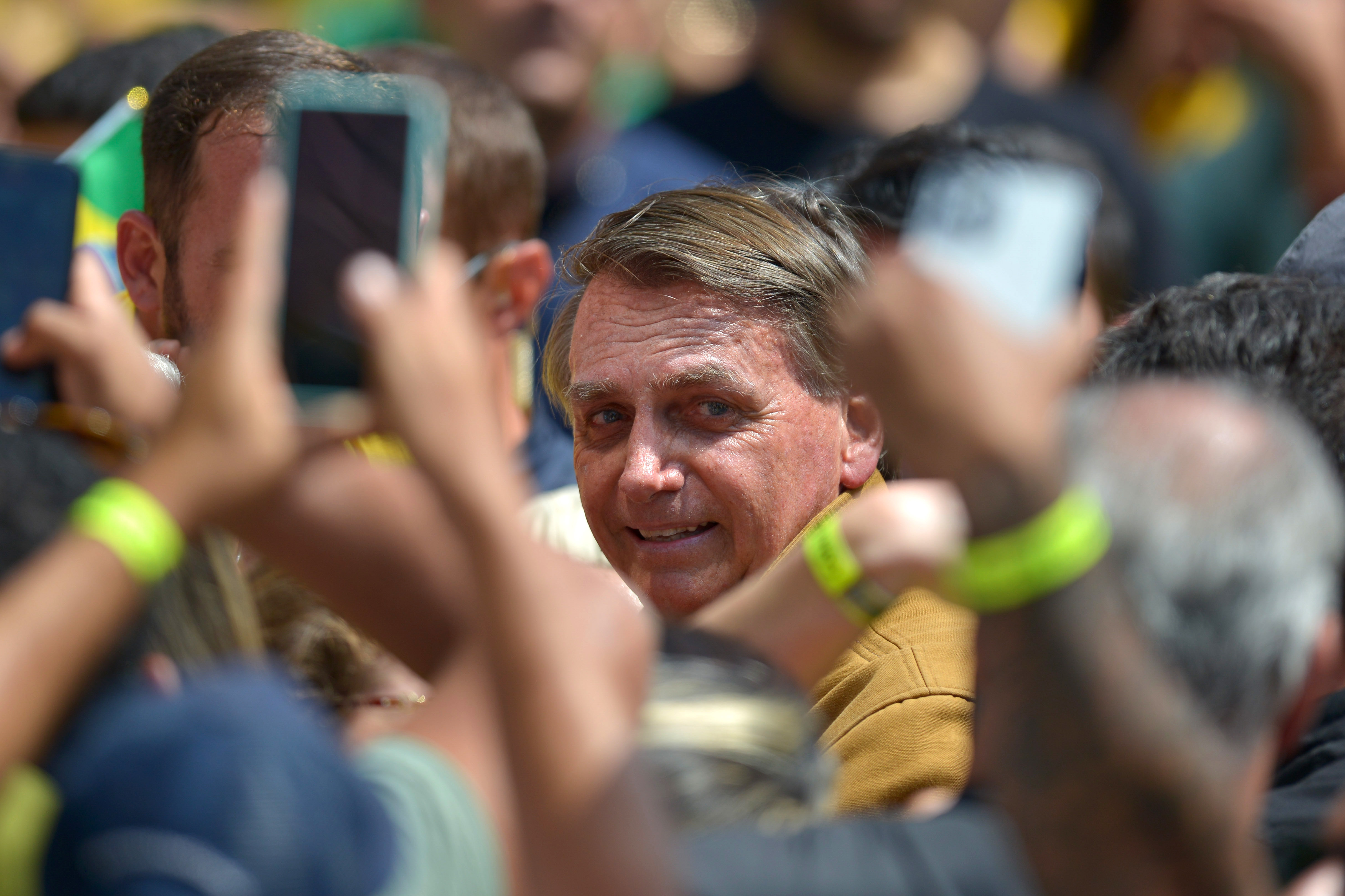 Brazil's President Jair Bolsonaro greets supporters during a reelection campaign rally. Ahead of the first round of voting on Oct. 2, Bolsonaro has baselessly claimed that voting machines will be rigged against him, an echo of former U.S. President Donald Trump's false claims about the 2020 election. (Getty Images)