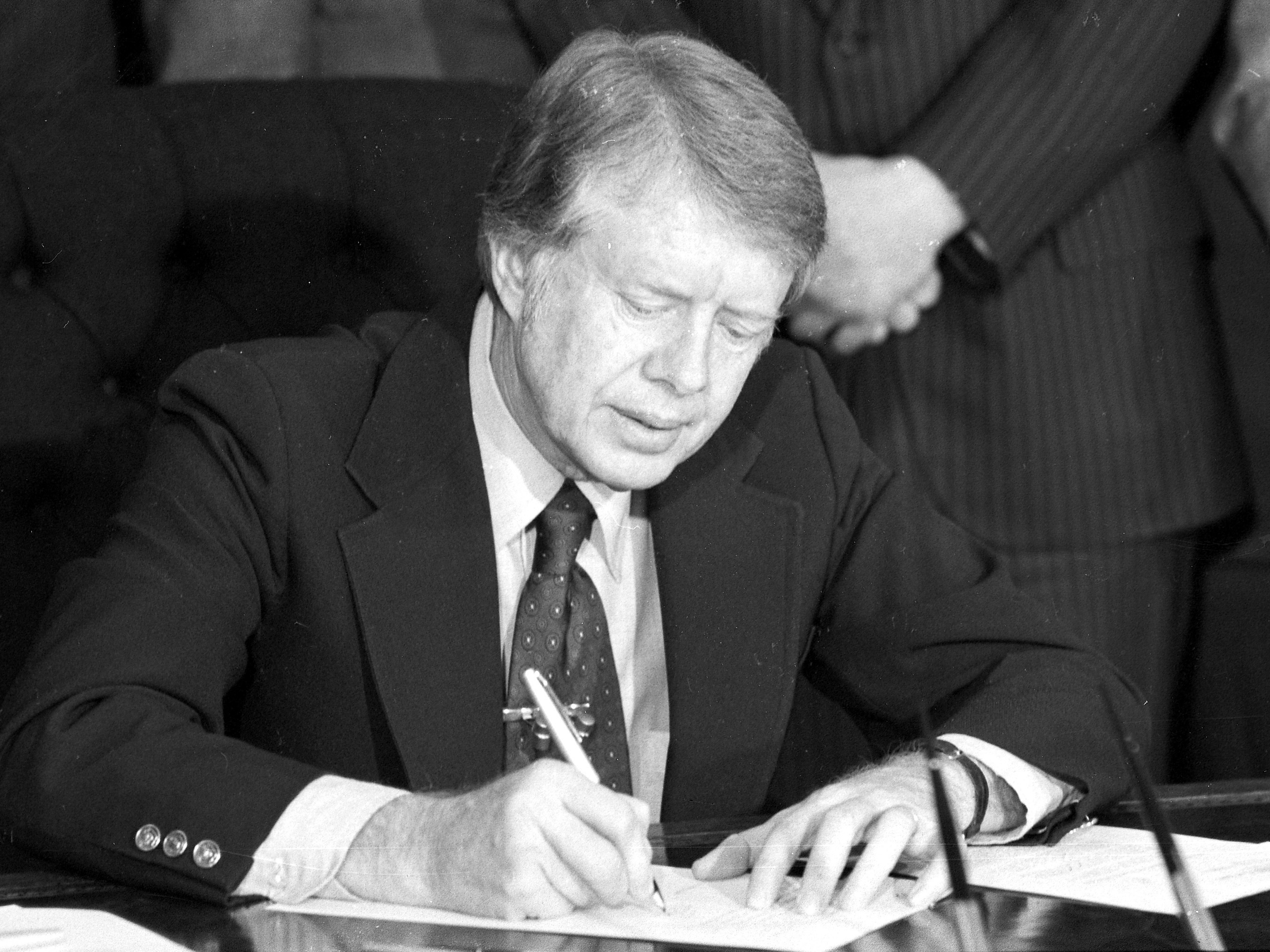 President Jimmy Carter signs an emergency natural gas legislation in the Oval Office of the White House in Washington, D.C., in 1977. (ASSOCIATED PRESS)