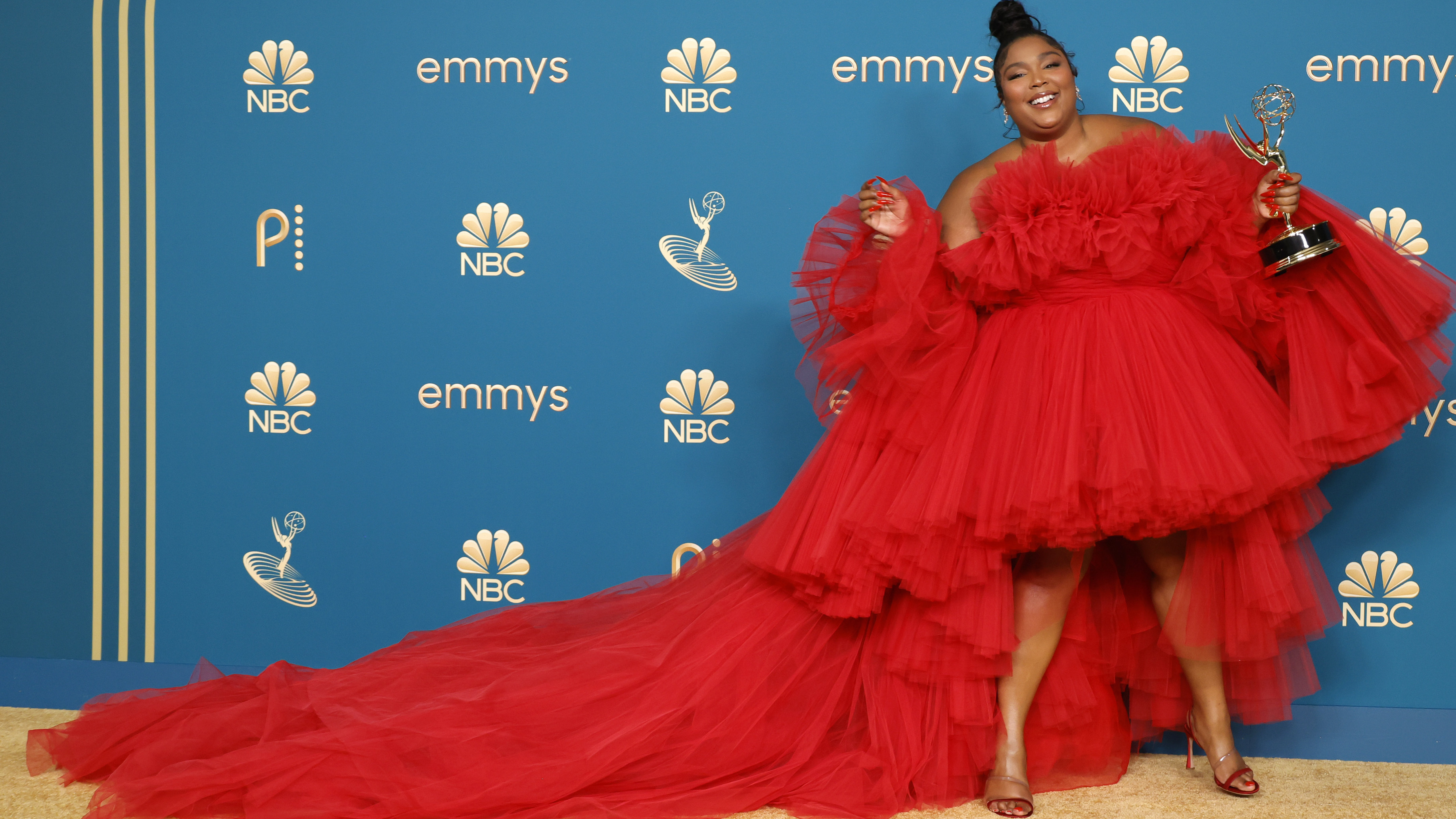 Lizzo poses after receiving an award for "Lizzo