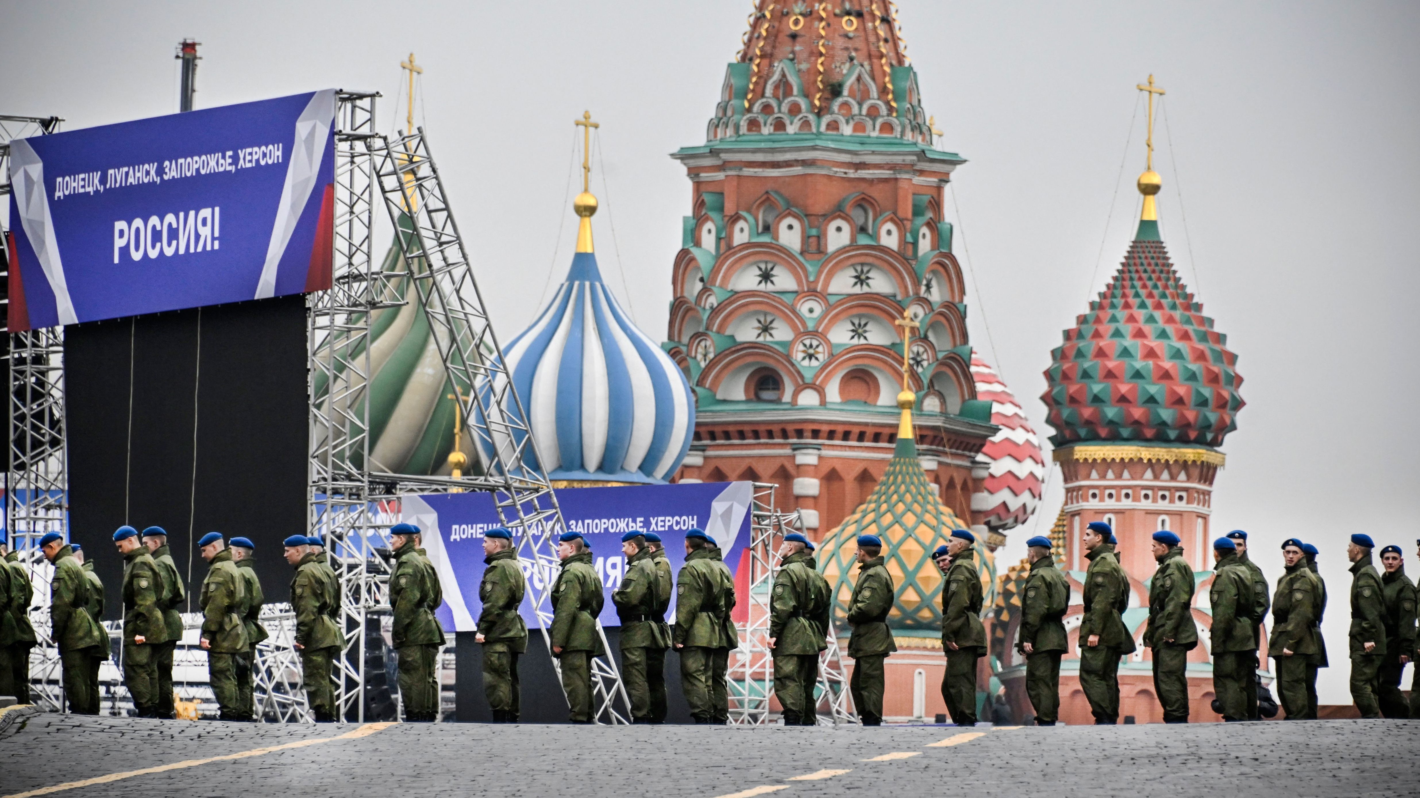 Russian soldiers stand on Red Square in central Moscow on Thursday as the square is sealed off prior to a ceremony for the alleged incorporation of new territories into Russia. Banners on the stage read: "Donetsk, Luhansk, Zaporizhzhia, Kherson — Russia!"