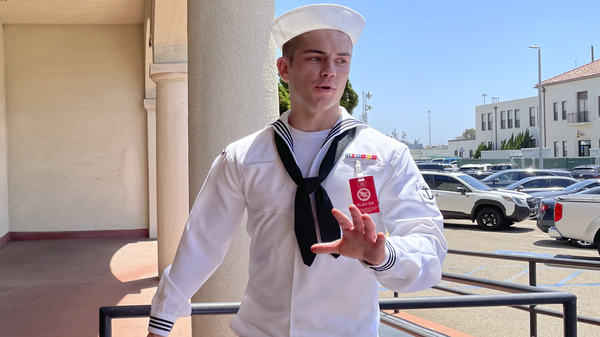 US Navy sailor Ryan Sawyer Mays walks past reporters at Naval Base San Diego before entering a Navy courtroom, Aug. 17, 2022, in San Diego.
